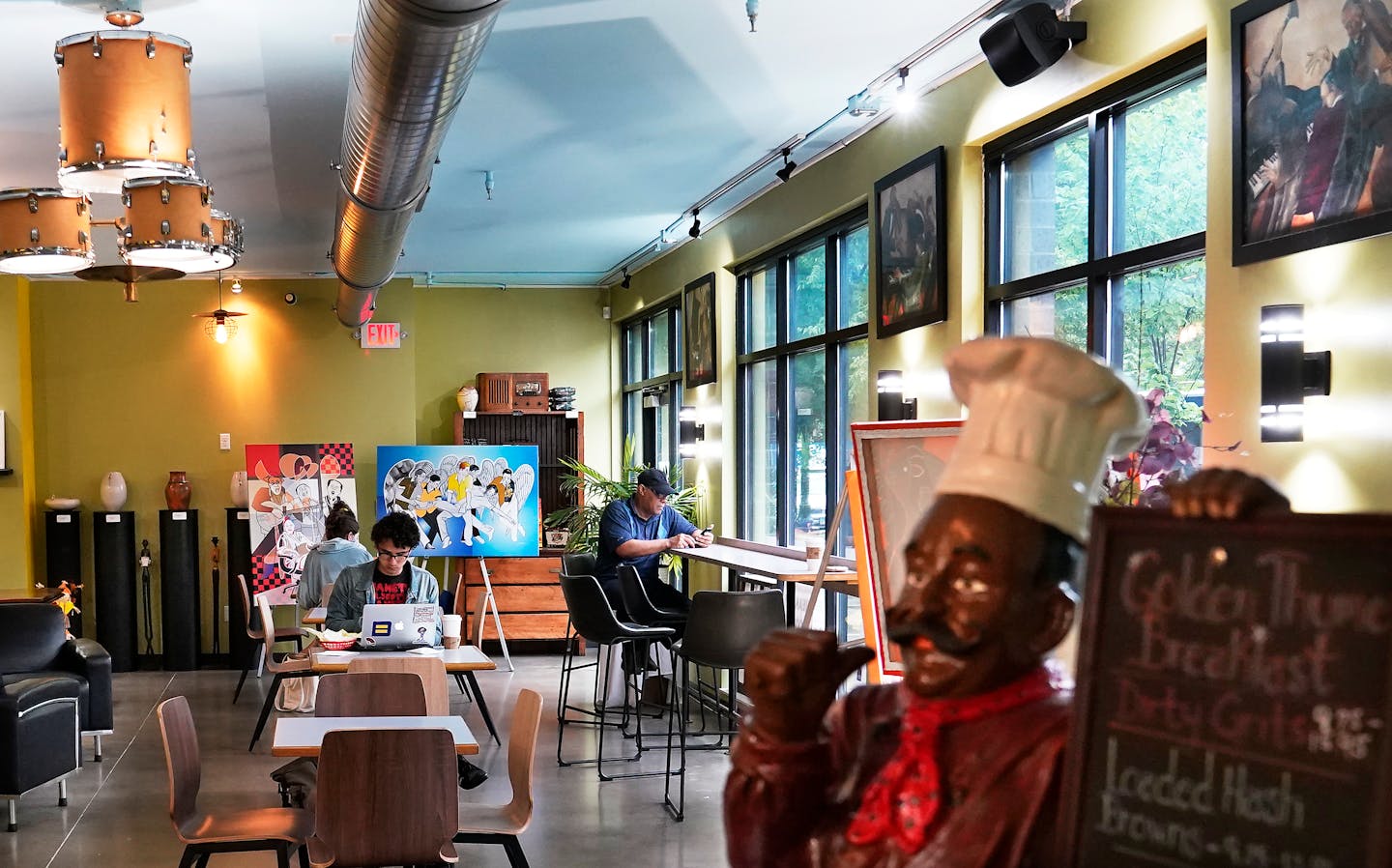 Mychael Wright, right, is the force behind the Selby Avenue Jazz Festival and was seen at his his coffee shop, Golden Thyme, Friday, in St. Paul. ]