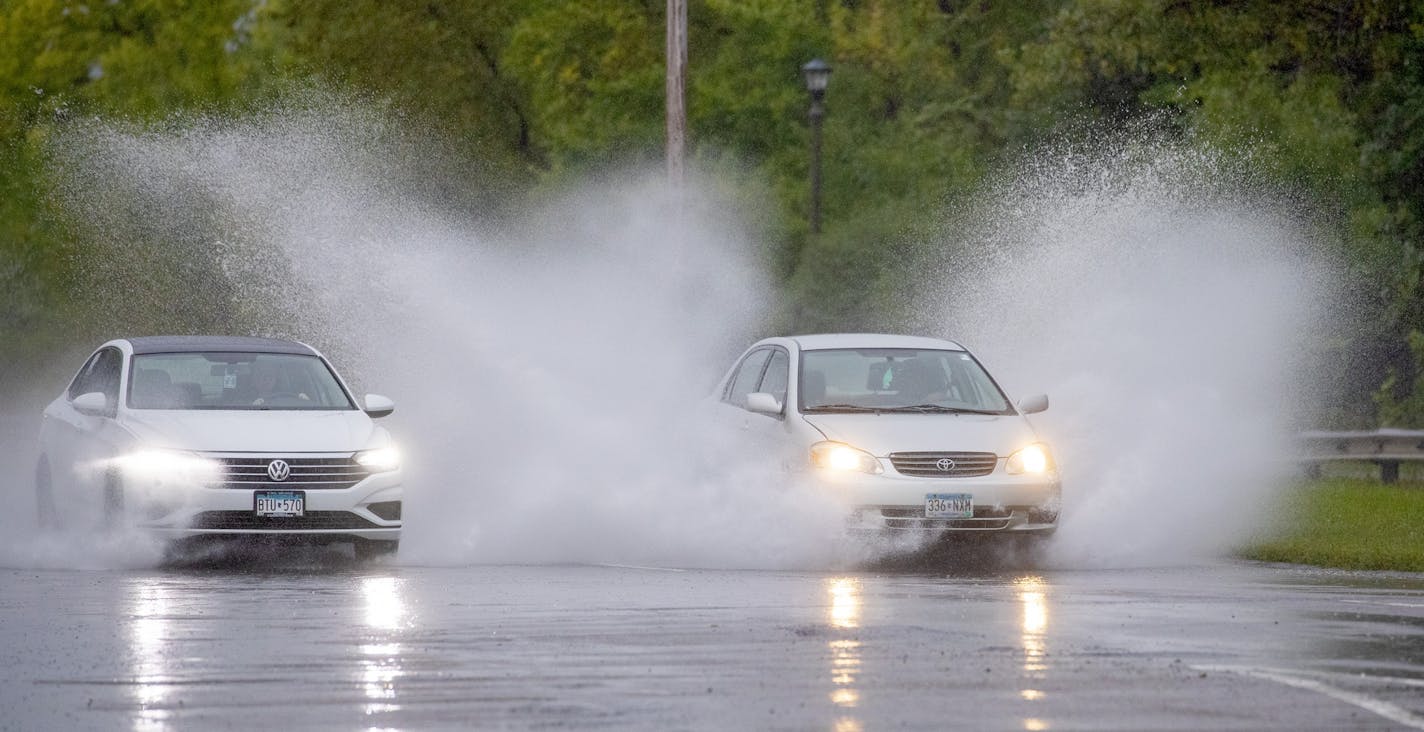 Traffic ran through flooded areas along Shepard Road and Homer Street in St. Paul Thursday, September 12, 2019. The Twin Cities could see one to two inches of rain Thursday.