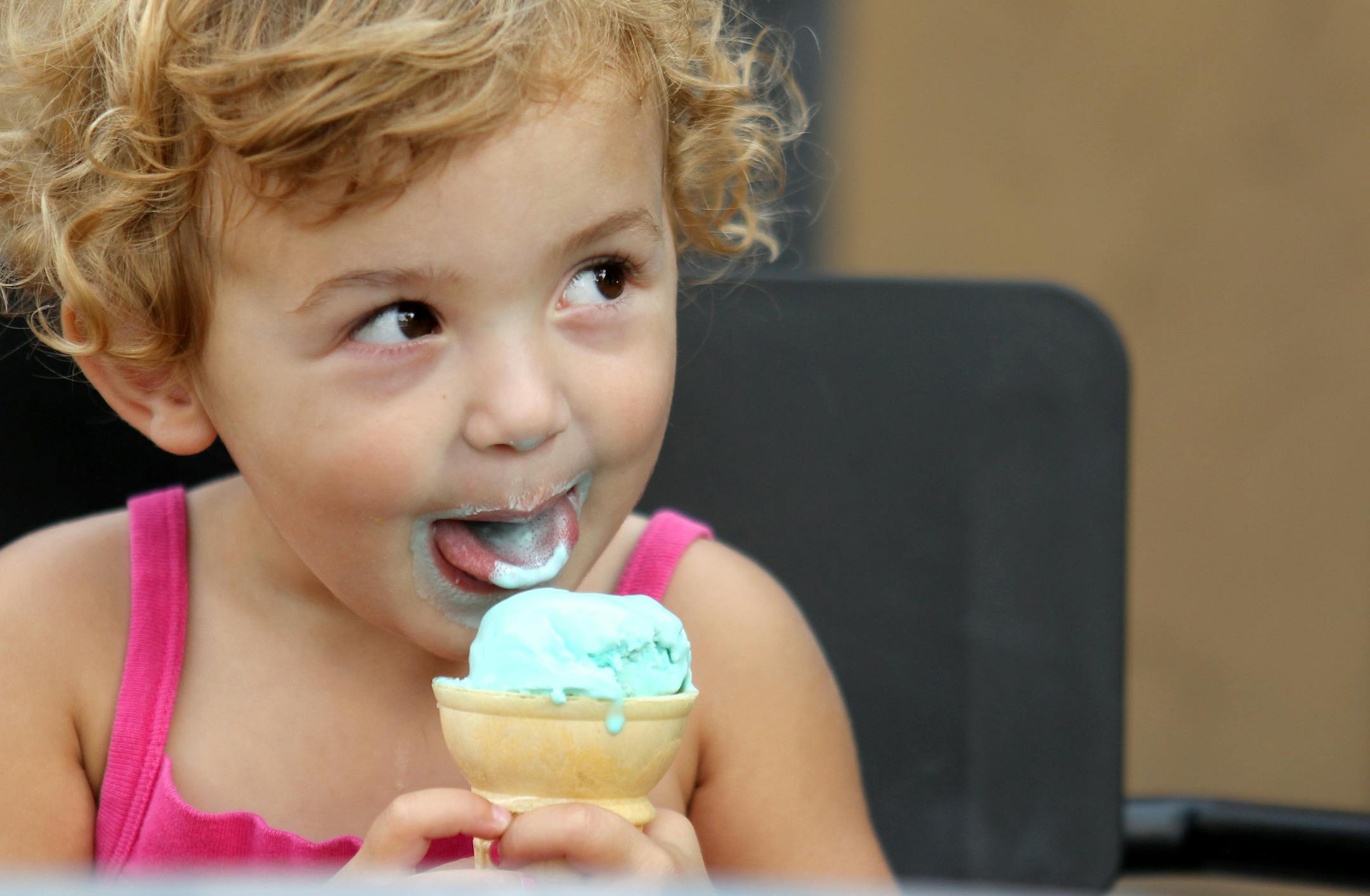 Vivian Spende, 2, of St. Paul, licks her cotton candy ice cream cone at Izzy's Ice Cream Cafe in St. Paul.