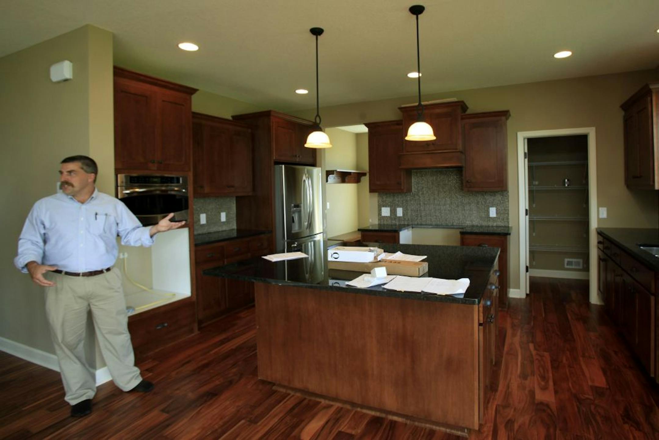 Bill Burgess of Lennar showed off the Next Gen home's floor plan, including the main kitchen, as workers put the finishing touches on the smaller suite aimed at multigenerational families. The Next Gen design is essentially a house within single-family