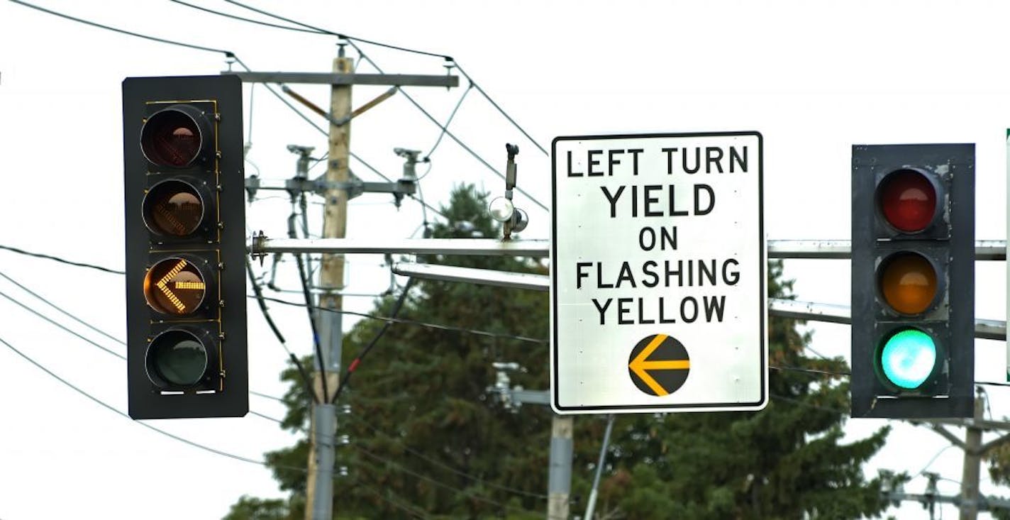 A flashing yellow arrow sign in Mendota Heights. The signal allows motorists to turn left if the coast is clear.