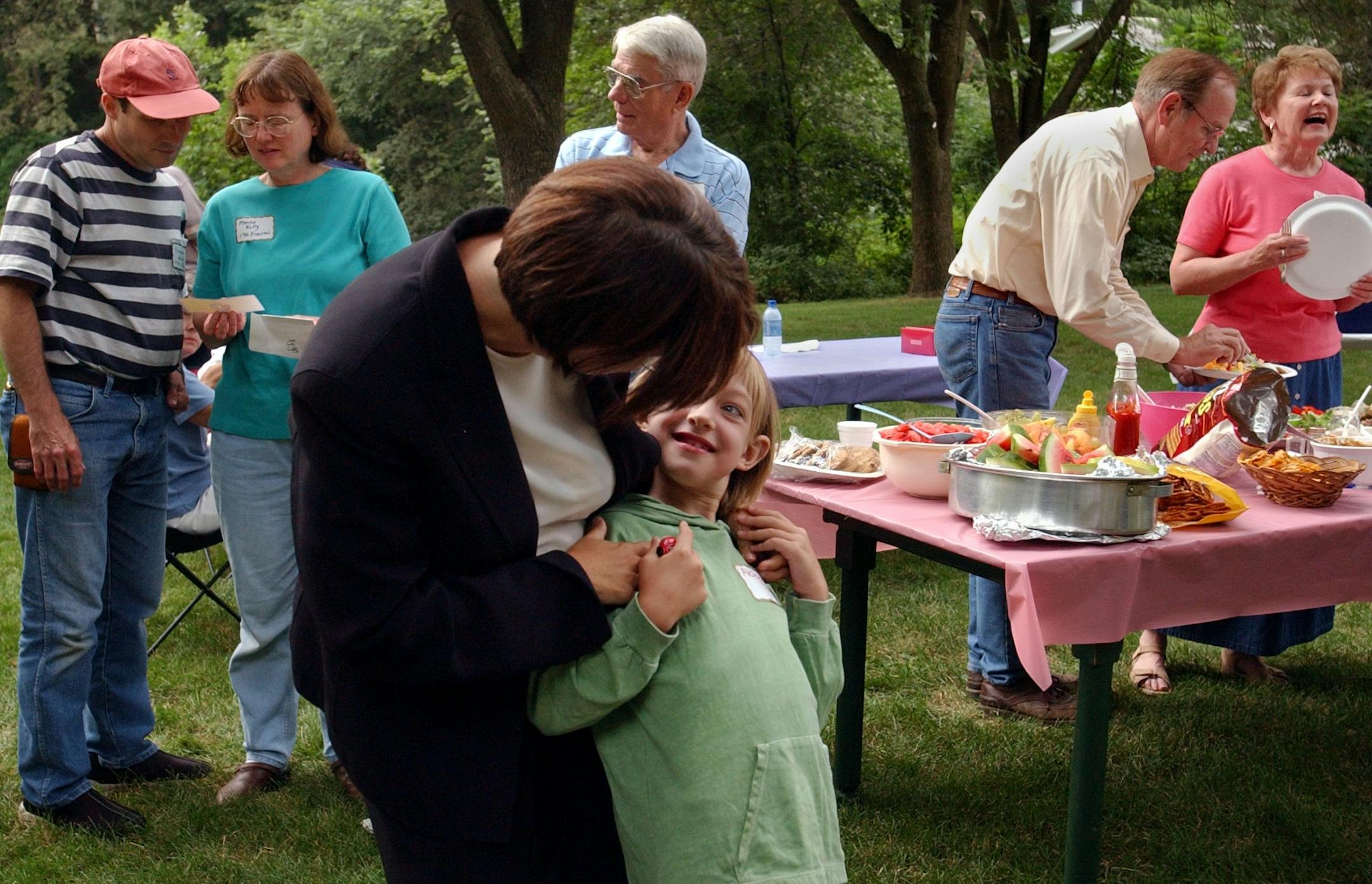 Plymouth, Mn.,Tues., Aug. 5, 2003--(Center) Hennepin County Attorney Amy Klobuchar checks to see if daughter Abigail has a ketchup or mustard mustache before Klobuchar, Abigail and her husband, John (need last name) headed of to their second of three National Night Out celebrations. Klobuchar first went to the Oakview Lane neighborhood party in Plymouth--the neighborhood where she grew up and where her mother still lives. GENERAL INFORMATION: National Night Out on Oakview Lane in Plymouth.