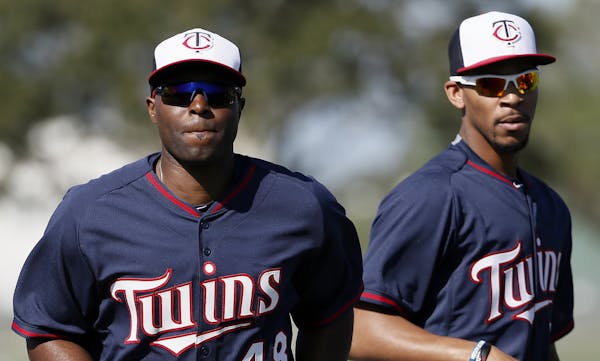 Minnesota Twins' Torii Hunter (48) and Byron Buxton, right, jog as they warm up before a workout at baseball spring training in Fort Myers, Fla., Tues