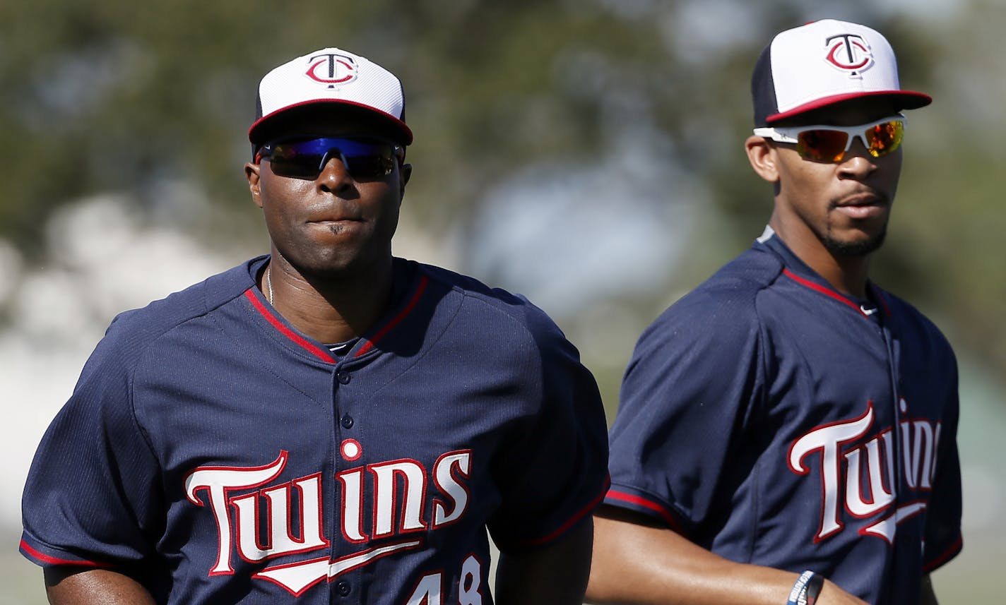 Minnesota Twins' Torii Hunter (48) and Byron Buxton, right, jog as they warm up before a workout at baseball spring training in Fort Myers, Fla., Tuesday March 3, 2015. (AP Photo/Tony Gutierrez) ORG XMIT: MIN2015032520010463 ORG XMIT: MIN1503252008194254