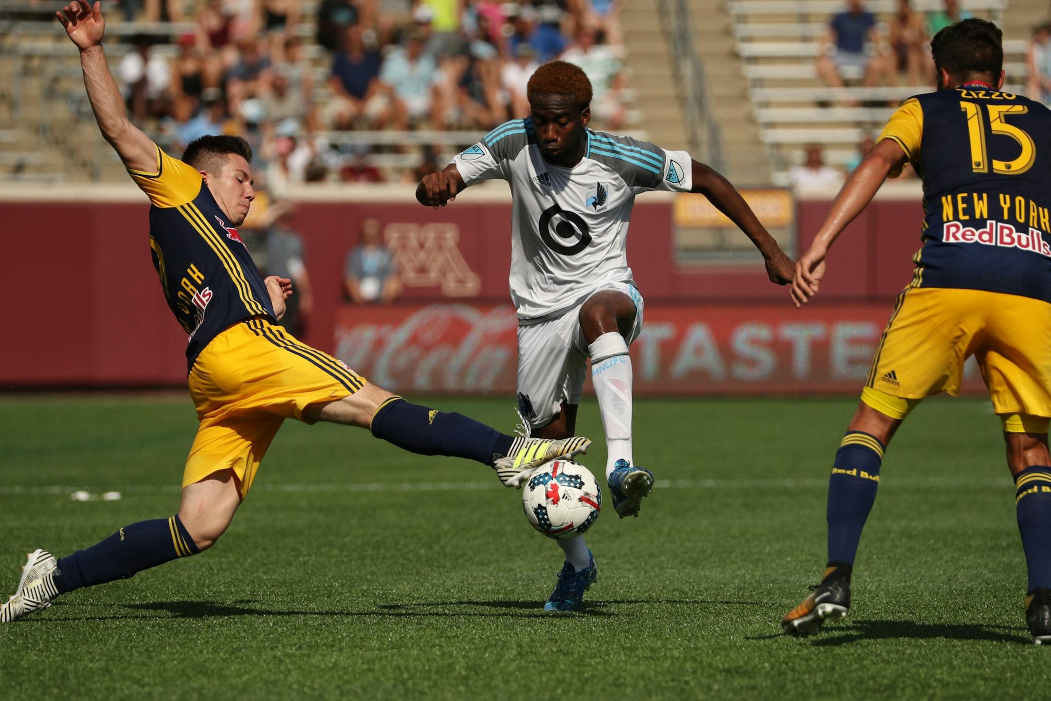 New York Red Bulls midfielder Alex Muyl (19) tried to take the ball from Minnesota United midfielder Kevin Molino (18) as he dribbled down field in the second half.