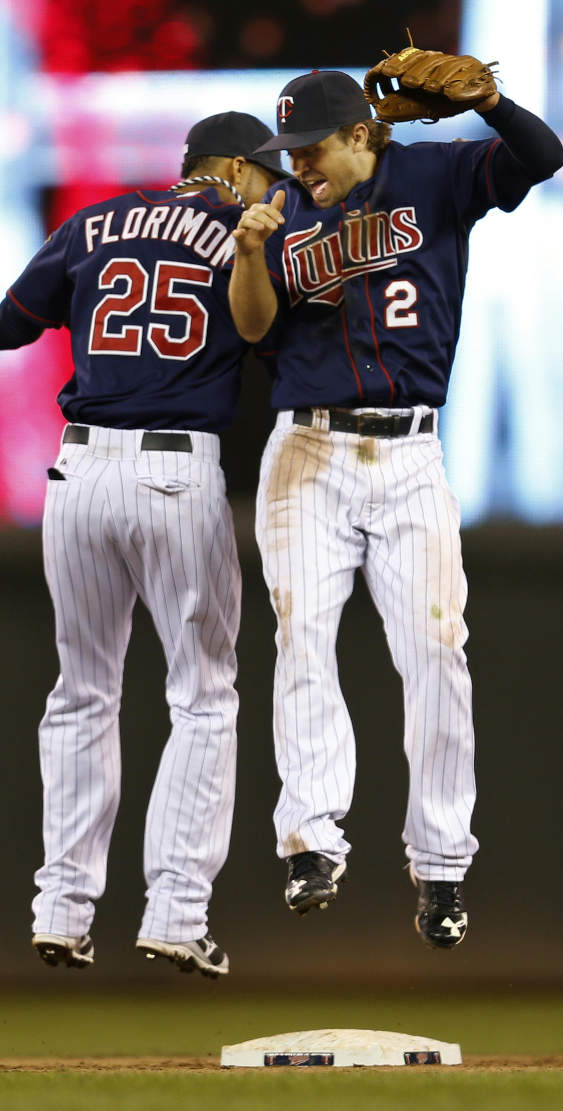 At the Twins game against the White Sox, Pedro Florimon(25) and Brian Dozier(2) celebrate the Twins' 10-3 win.]rtsong-taatarii@startribune.com