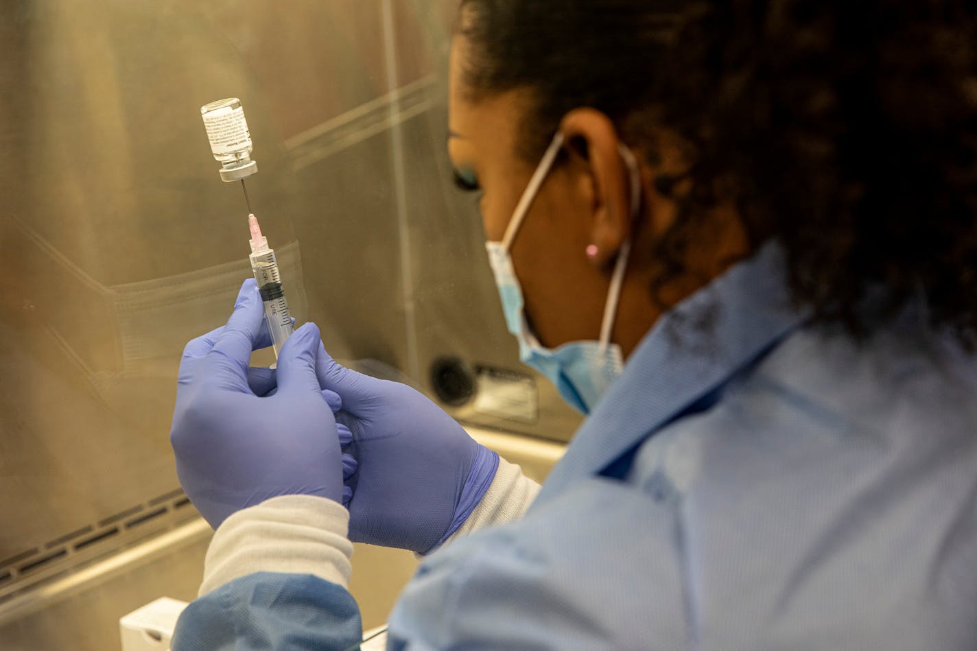 A pharmacist in Chandler, Ariz. prepares an injection during a trial for Regeneron's antibody treatment, Aug. 12, 2020.