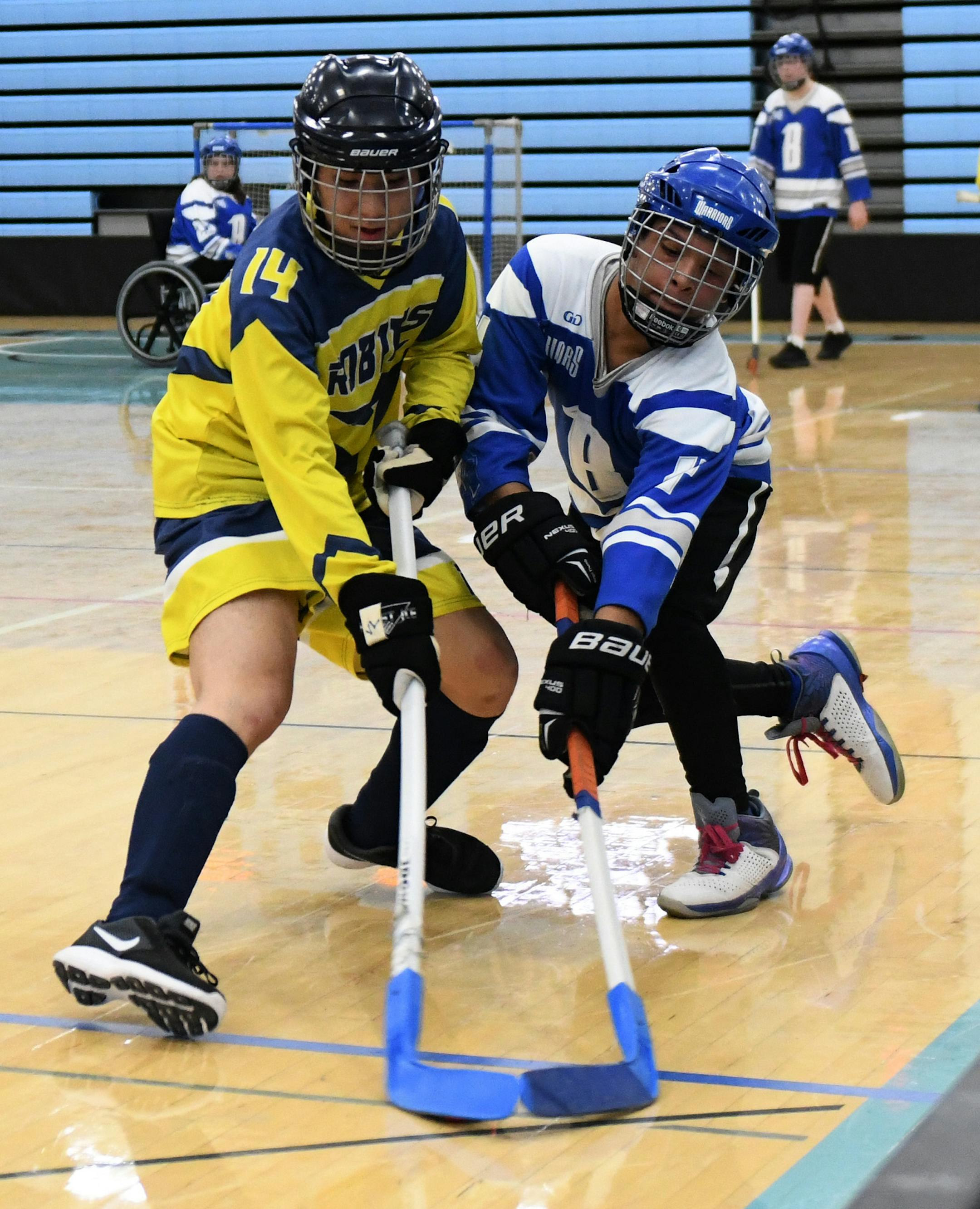 Brainerd center Tre'Von Otey (4) and Robbinsdale/Hopkins/Mound West forward Nick Johnson (14) fought for the puck. ] COURTNEY DEUTZ • courtney.deutz@startribune.com on Saturday, March 16, 2019 at Thomas Jefferson High School in Bloomington. The high school adapted floor hockey physically impaired state championship game.