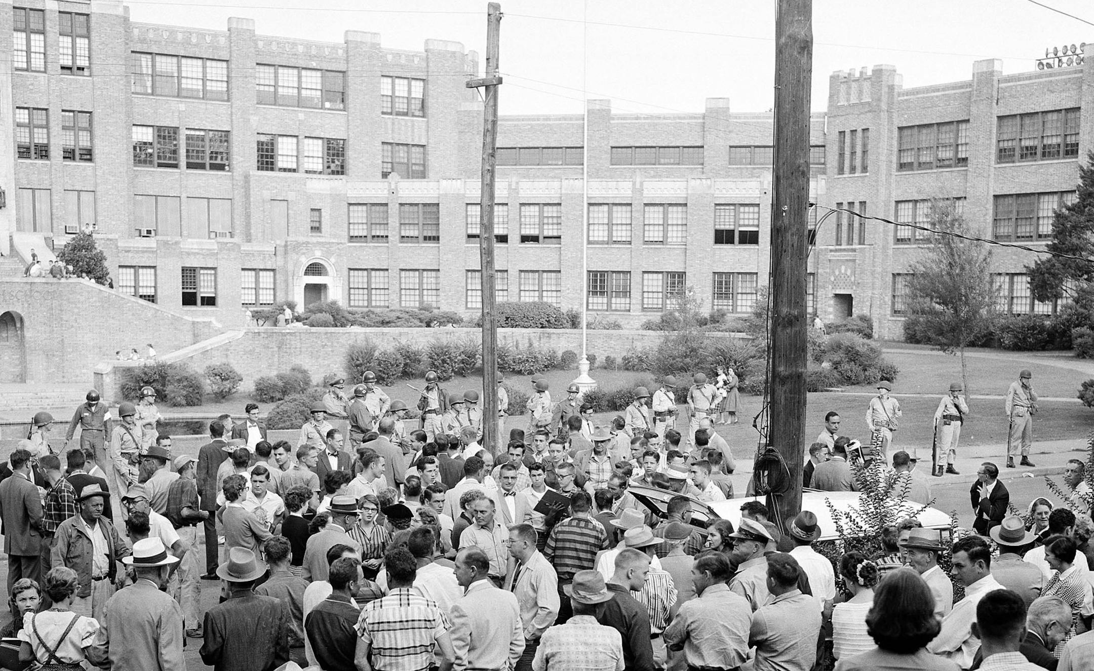** FILE ** In this on Sept. 9, 1957, file photo, a crowd of students, reporters and curious onlookers watch the scene as Arkansas National Guard troops, following the orders of Gov. Orval Faubus, are dispatched to prevent nine black students from entering Little Rock's all-white Central High School. The city is marking the 50th anniversary of Central High School's integration in September 2007 with a series of events culminating in a ceremony featuring former president Clinton and the Little Roc