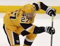 Pittsburgh Penguins' Nick Bjugstad gets off a pass during the first period of an NHL hockey game against the Chicago Blackhawks in Pittsburgh, Saturda