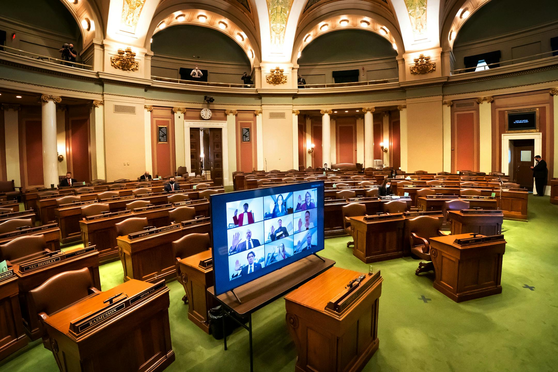 In an almost empty House Chamber, most legislators were sworn in remotely in groups of nine at a time, via Zoom at the Minnesota State Capitol. A few took the oath in person earlier.