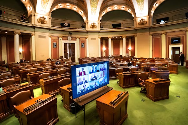 In an almost empty House Chamber, most legislators were sworn in remotely in groups of nine at a time, via Zoom at the Minnesota State Capitol. A few 