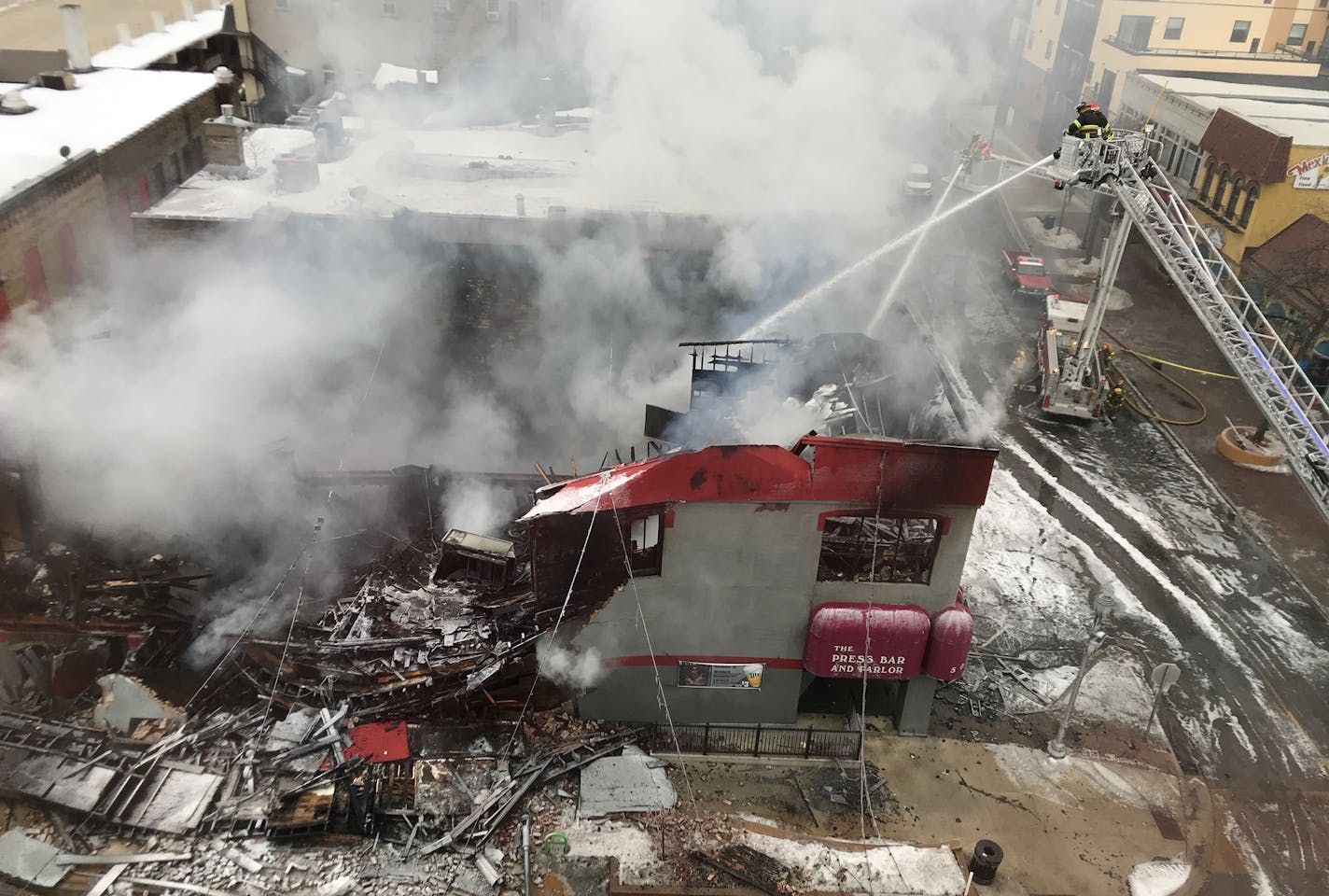 A popular downtown St. Cloud, Minn., bar is a total loss after fire gutted the building early Monday. Crews will begin razing the Press Bar and Parlor at 502 W. St. Germain St. and work throughout the morning to put out the fire, which was reported around 2:40 a.m., said St. Cloud Battalion Fire Chief Jerry Raymond. Part of the building collapsed and the structure &#x201c;is a total loss,&#x201d; Raymond said. &#x201c;By the end of the day it will be gone.&#x201d; (Jason Wachter/Special to the S