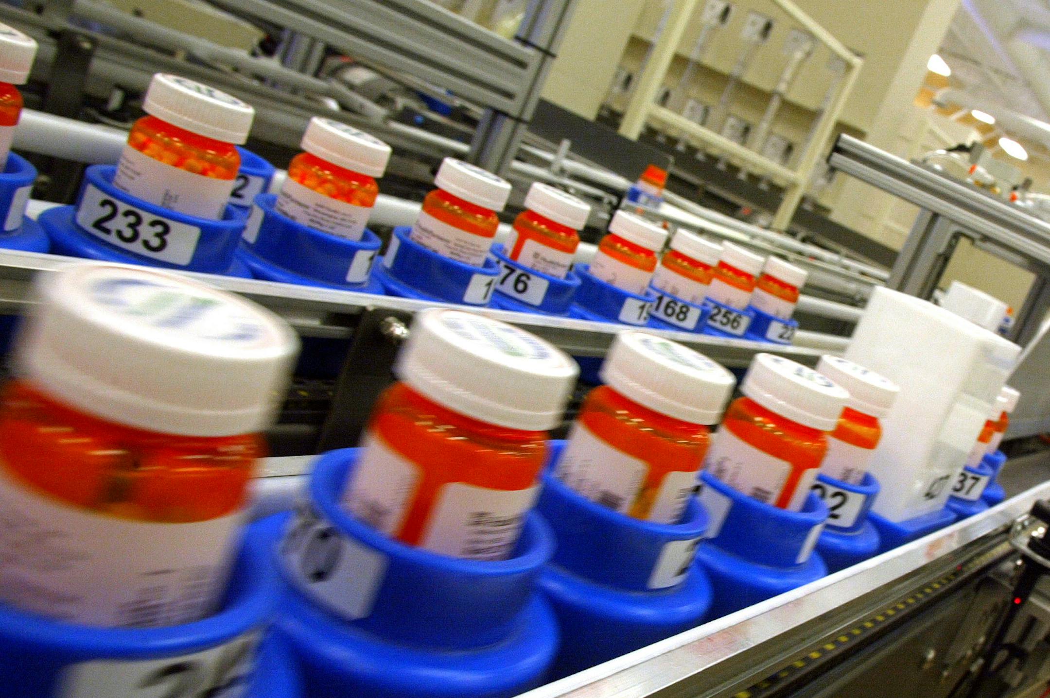 Filled prescriptions zipped down an automated conveyor belt.