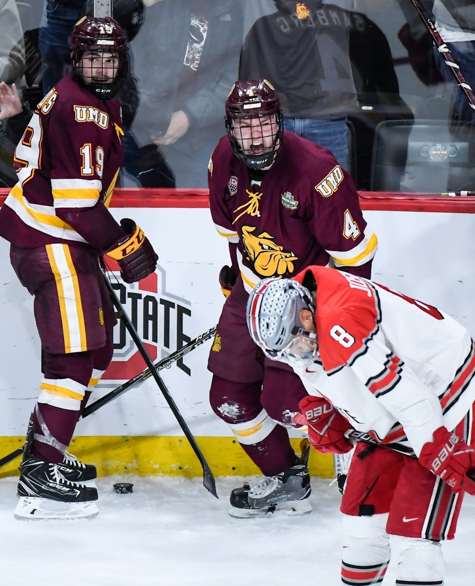 Minnesota-Duluth Bulldogs defenseman Dylan Samberg (4) and forward Justin Richards (19) reacted as the clock wound down on their 2-1 victory against O