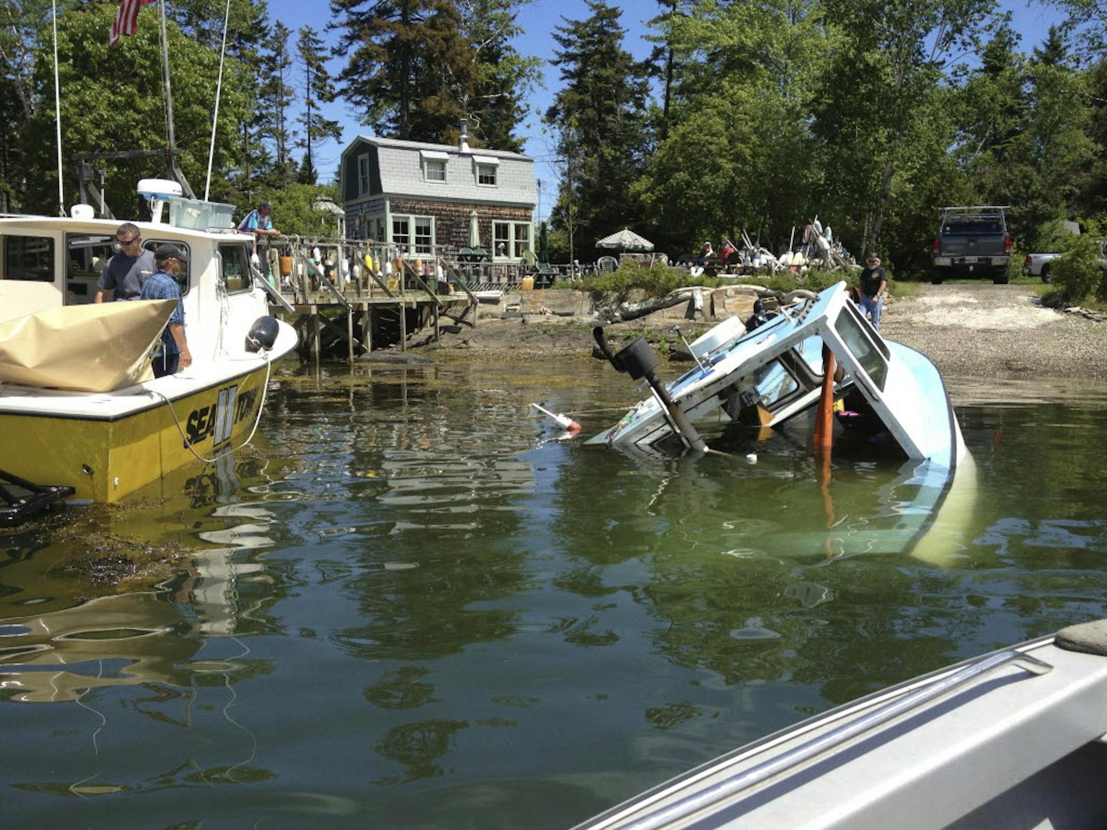 The lobsterboat "Queen Tut" owned by Philip Tuttle is brought to a dock in Harpswell, Maine. Tuttle, a 90-year-old lobsterman, survived the sinking of his boat by swimming to a nearby island through the icy waters of the Gulf of Maine.