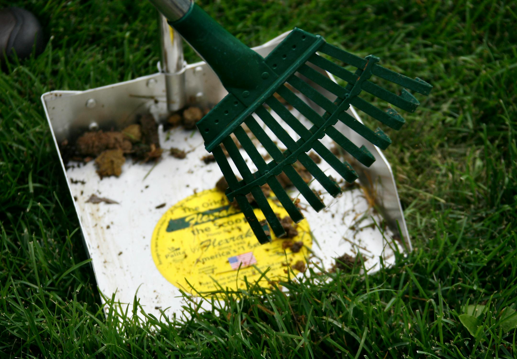 Steve Rice ¥ srice@startribune.com St. Louis Park, 08/21/2007 - Gail Behrens-McArdle from "Pet Yard Pick-Up picks up dog waste from a yard in St. Louis Park.