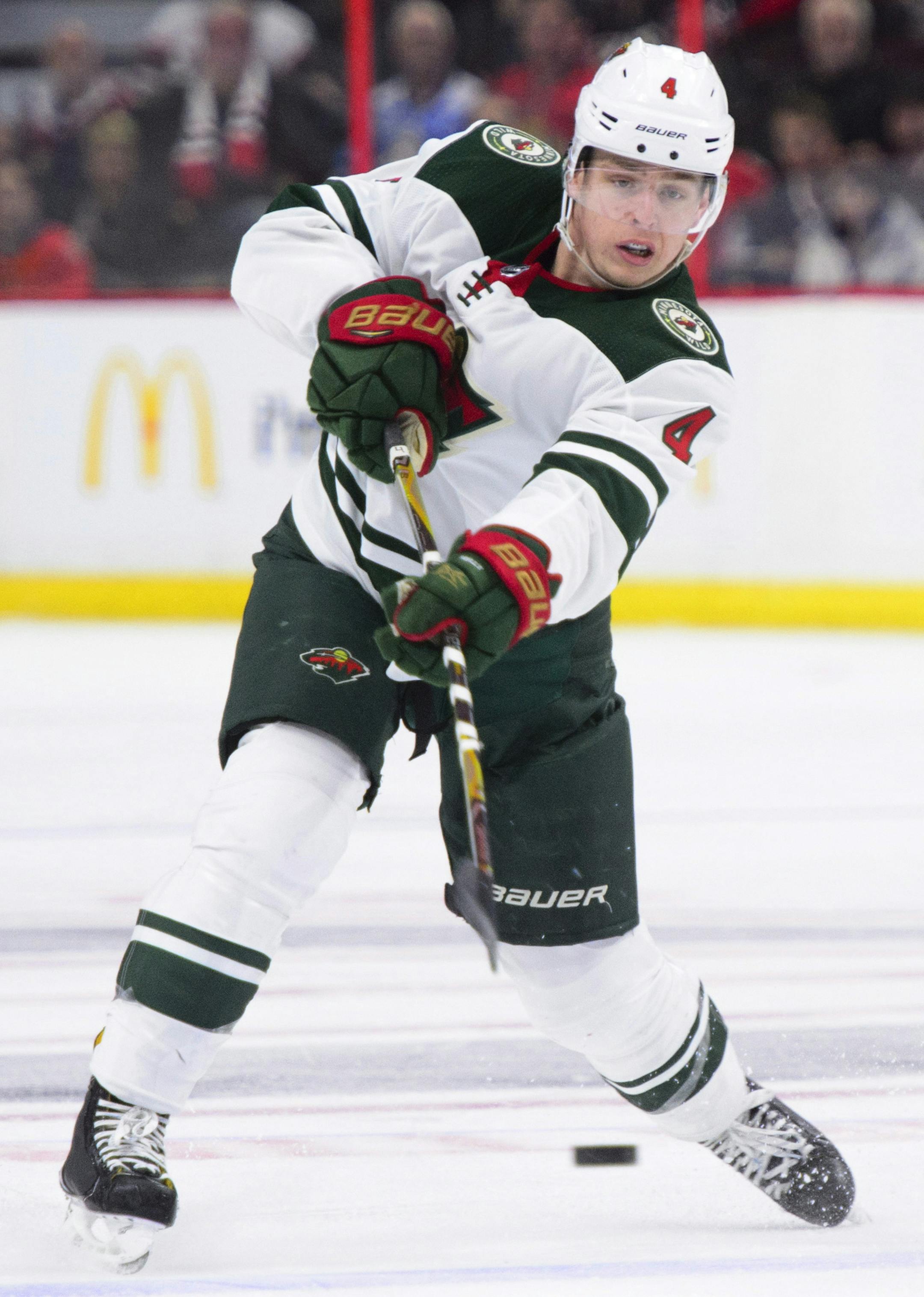 Minnesota Wild's Mike Reilly dumps the puck past Ottawa Senators' Mark Stone during third period NHL hockey action in Ottawa on Tuesday, Dec. 19, 2017. (Sean Kilpatrick/The Canadian Press via AP) ORG XMIT: MIN2017121921083040