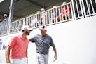 Tom Lehman put his arms around Matthew Wolff as the two walked back toward the clubhouse after finishing the third round of the 3M Open Saturday. ] Aa