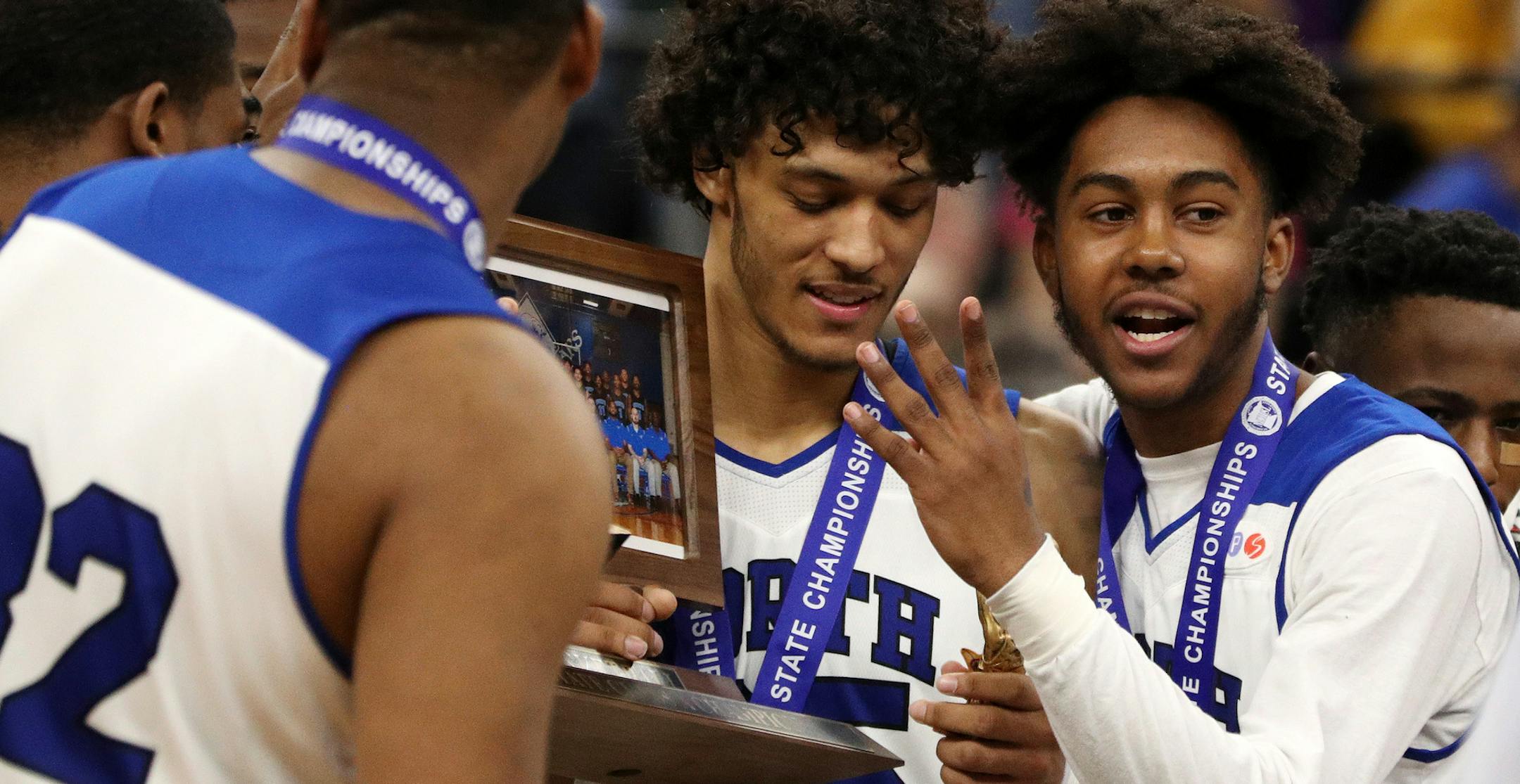 Minneapolis North Community High School players including guard Isaac Johnson (35), center, celebrate with their first place trophy. ] ANTHONY SOUFFLE &#xef; anthony.souffle@startribune.com Players competed during the boys' basketball state tournament Class 1A championship game between the North Woods High School and the Minneapolis North Community High School Saturday, March 25, 2017 at the Target Center in Minneapolis.