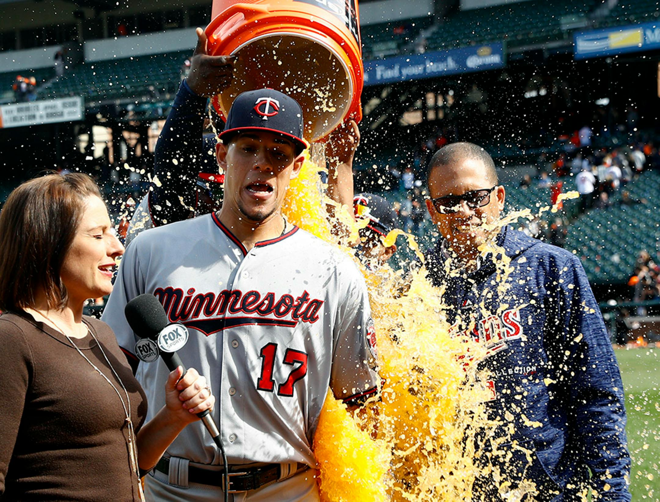 Minnesota Twins starting pitcher Jose Berrios, center, reacts as he is doused during a postgame television interview after a baseball game against the Baltimore Orioles, Sunday, April 1, 2018, in Baltimore. Berrios pitched a complete game and Minnesota won 7-0.
