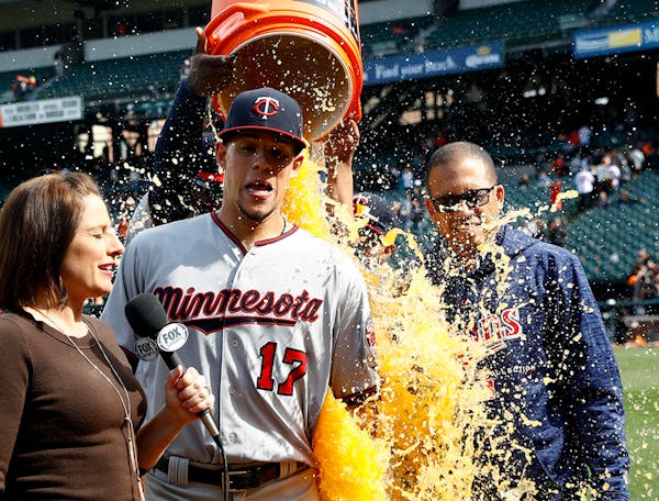 Minnesota Twins starting pitcher Jose Berrios, center, reacts as he is doused during a postgame television interview after a baseball game against the