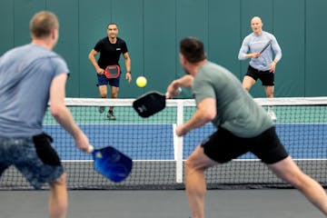 Eric Theriault, left, RJ Singh, Freddy Akradi and Aleks Westlund play a match at Life Time Chanhassen Pickleball in April. The facility next to the co