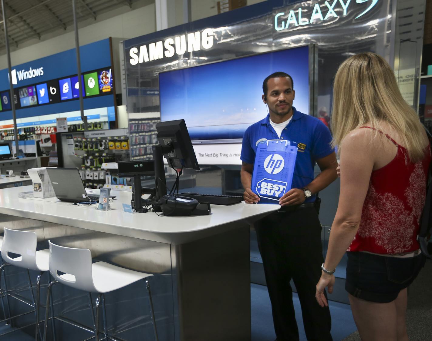 With its recent partnerships with Samsung and Microsoft, Best Buy has been one of the most aggressive proponent of the store within a store concept. Best Buy employee Phillip Stewart chatted with customer Karen Karpenko in the Samsung store in Best Buy in Richfield, Minn. on Wednesday, July 10, 2013. ] (RENEE JONES SCHNEIDER * reneejones@startribune.com)