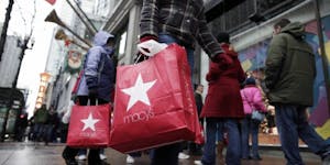 In this photo made Dec. 19, 2009, shoppers walk outside Macy's along State Street in Chicago. Retailers head into the home stretch this week hoping pe