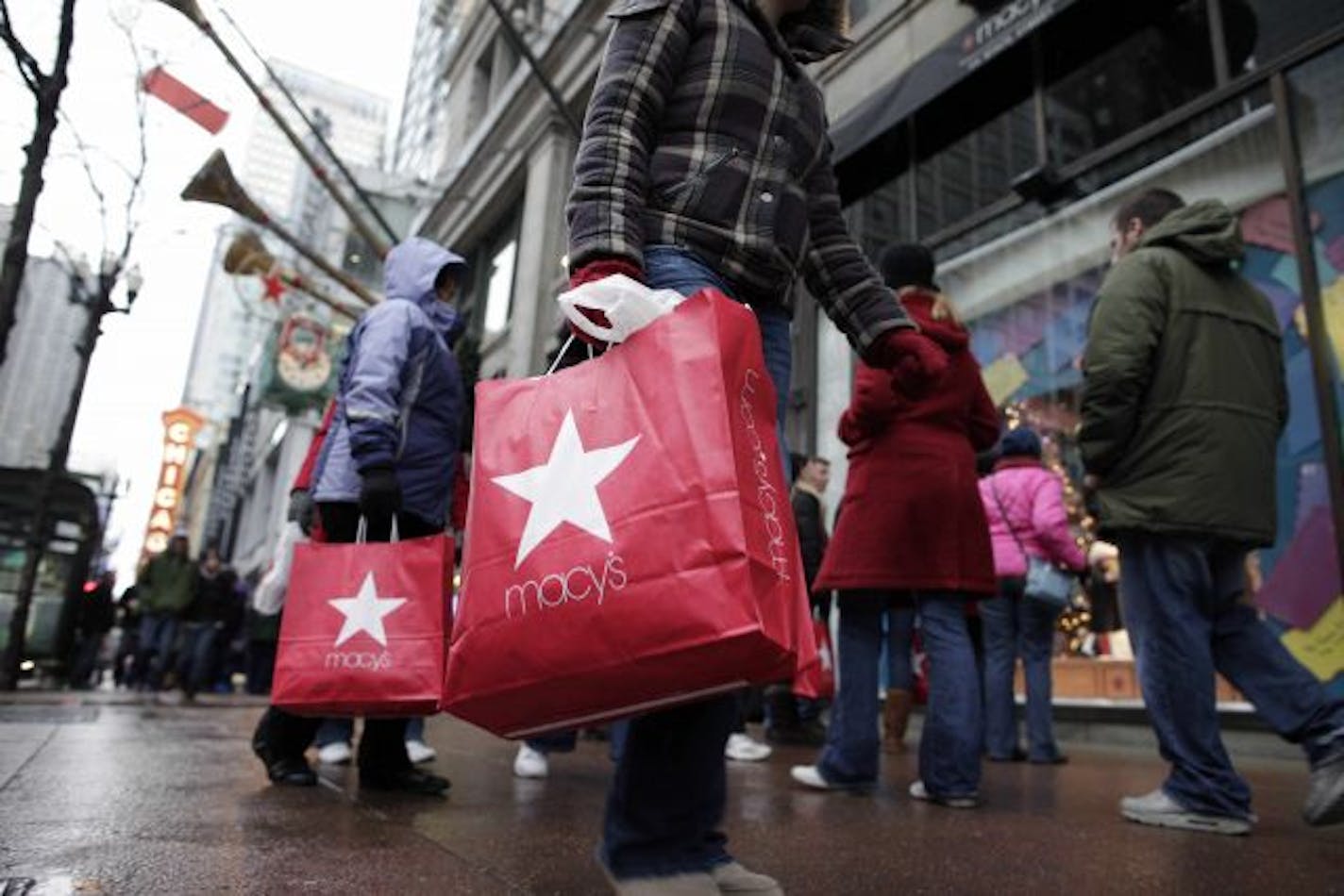 In this photo made Dec. 19, 2009, shoppers walk outside Macy's along State Street in Chicago. Retailers head into the home stretch this week hoping pent-up demand will give them one last gift before Christmas.