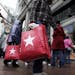 In this photo made Dec. 19, 2009, shoppers walk outside Macy's along State Street in Chicago. Retailers head into the home stretch this week hoping pe