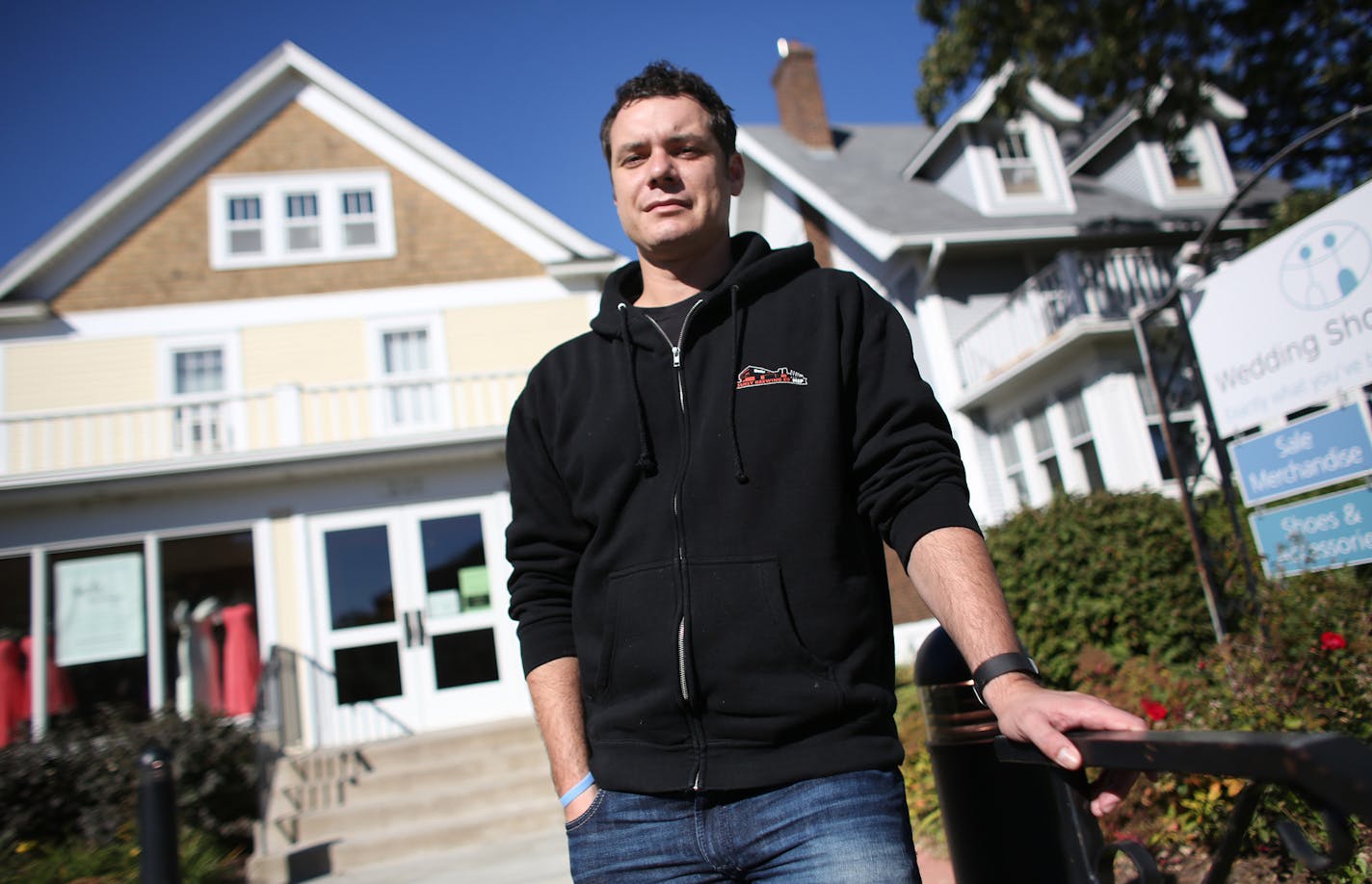 Jimmy Fritz, president of Wedding Shoppe, stood out in front of one of their buildings on Grand Ave. Fritz take about not being able to see the benefits to metered parking. ] (KYNDELL HARKNESS/STAR TRIBUNE) kyndell.harkness@startribune.com On Grand Avenue in St Paul Min., Thursday October 1, 2015. St. Paul's plan to test metered parking on Grand Avenue, the city's best known commercial strip, has merchants and businesses seeing red. The council is expected to approve the measure in mid-October.