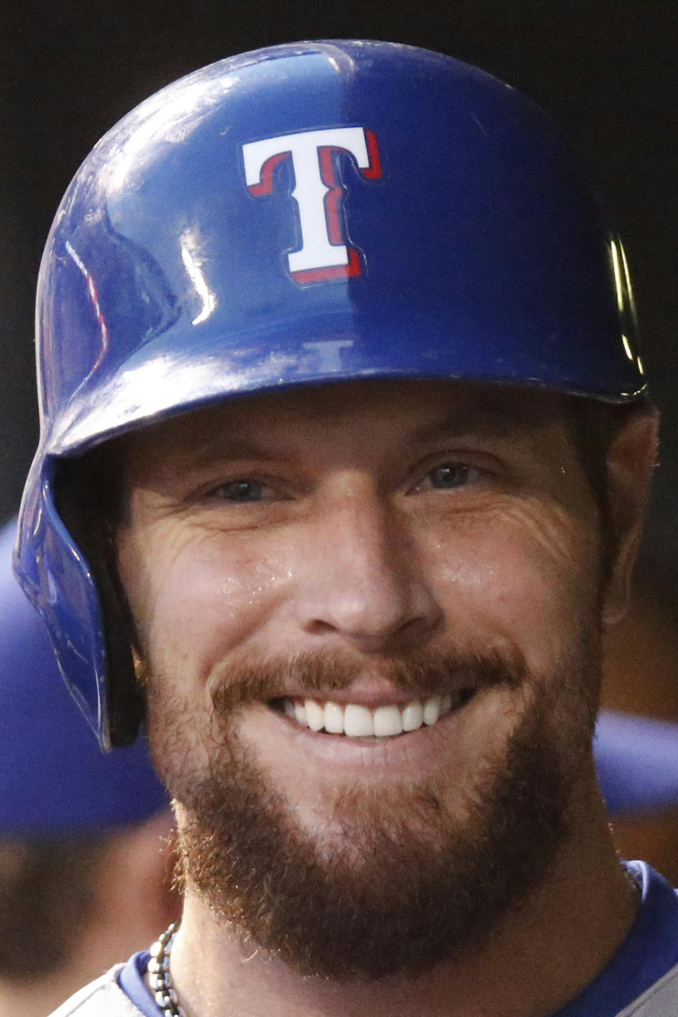 Texas Rangers left fielder Josh Hamilton (32) is congratulated after scoring against the Colorado Rockies in the fifth inning of an inter league baseball game Tuesday, July 21, 2015, in Denver. (AP Photo/David Zalubowski) ORG XMIT: OTKDZ137