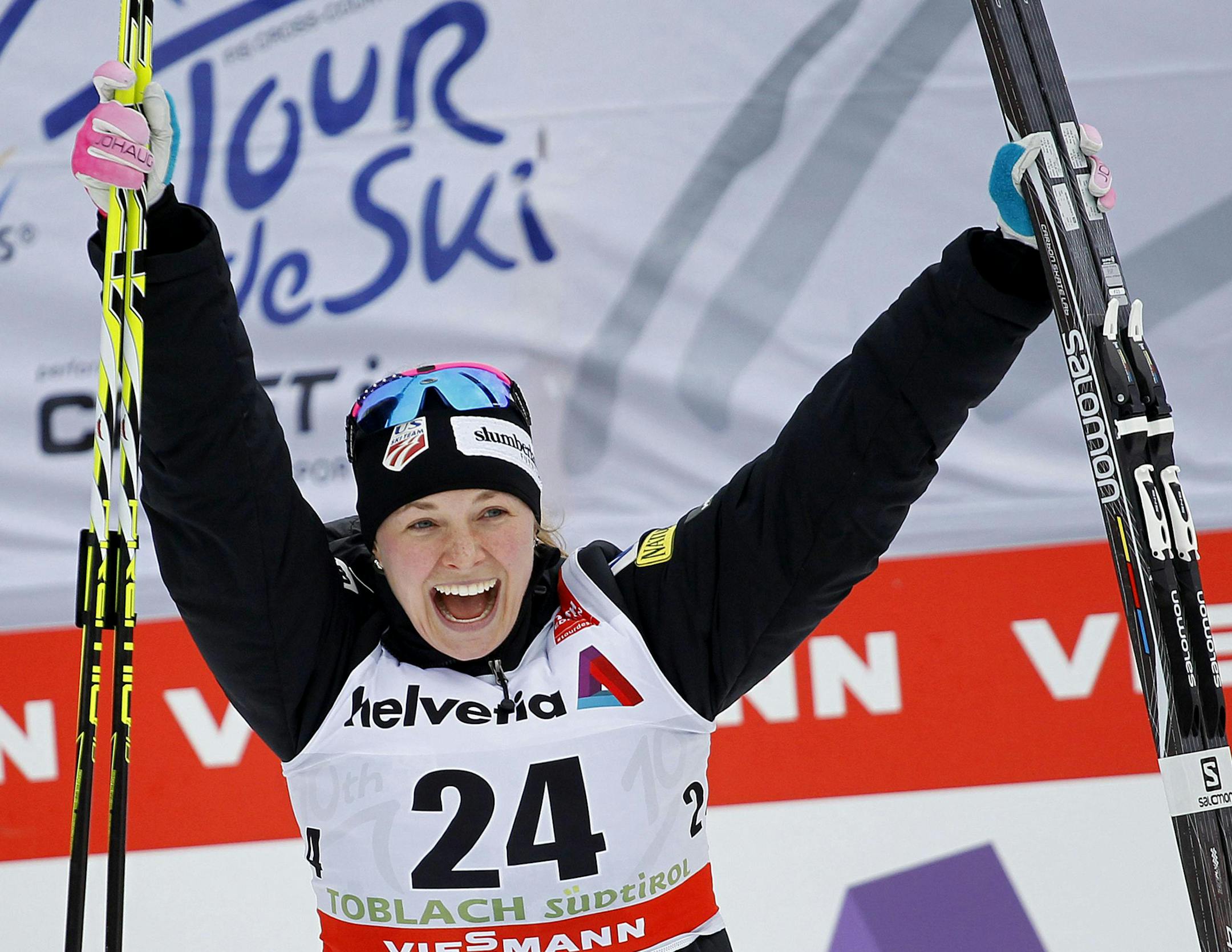 Jessica Diggins of The United States celebrates in the finish area after winning the Tour de Ski, women's 5-kilometer free pursuit cross-country ski event, in Dobbiaco (Toblach), Italy, Friday, Jan. 8, 2016. (Andrea Solero/Ansa via AP)