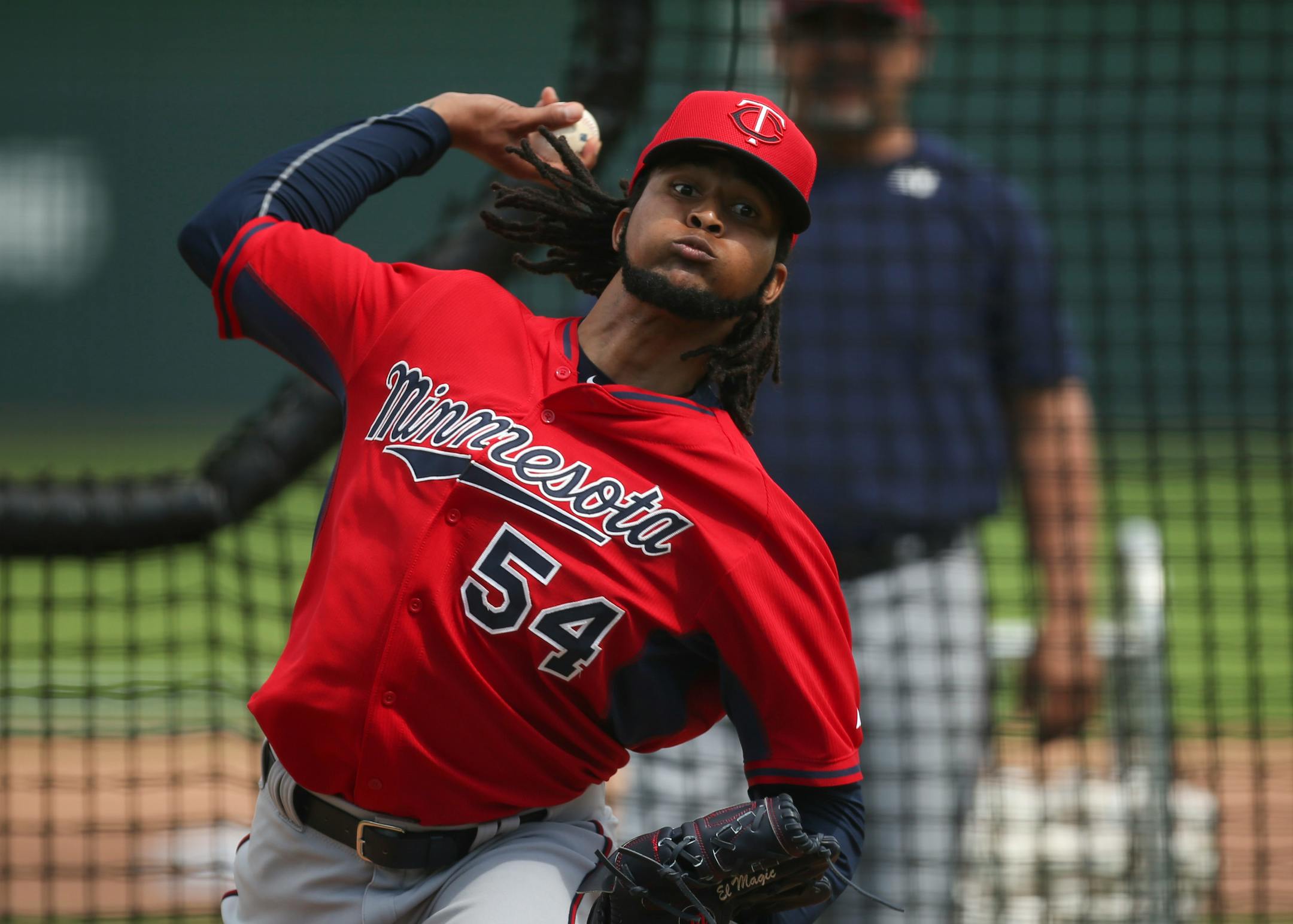 Twins pitcher Ervin Santana's glove is stitched with the moniker "El Magic." Bullpen coach Eddie Guardado watched him throw during batting practice March 1 at Hammond Stadium.