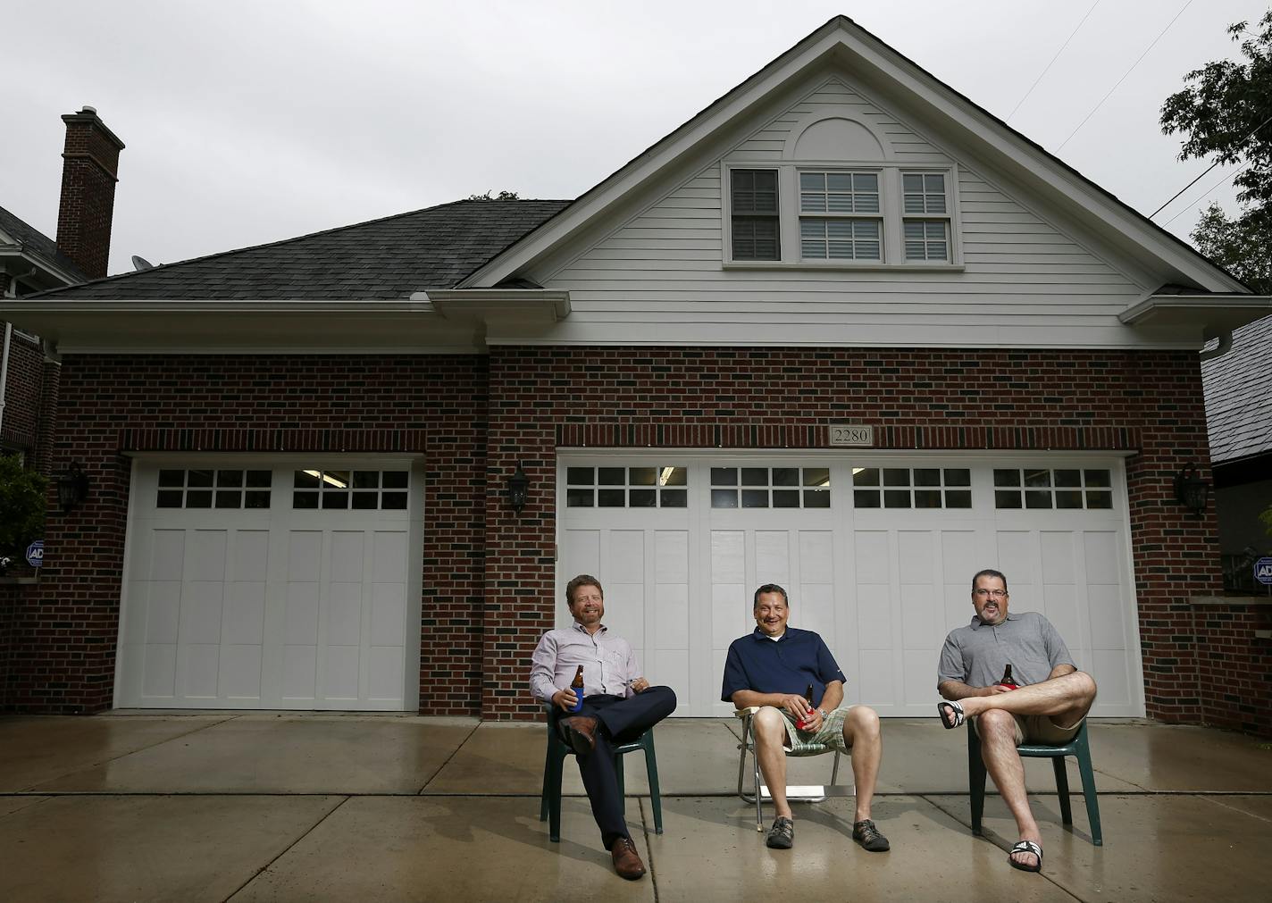 William Clabots, John Francis and Michael Traynor photographed in front of Francis' garage in St. Paul. ] CARLOS GONZALEZ cgonzalez@startribune.com - June 3, 2015, St. Paul, MN, It started as a way for John Francis to celebrate his new garage by inviting over some guys for beers and cigars the night before Father's Day in 2012. His Father's Eve bash became an annual tradition and way for the men to connect.