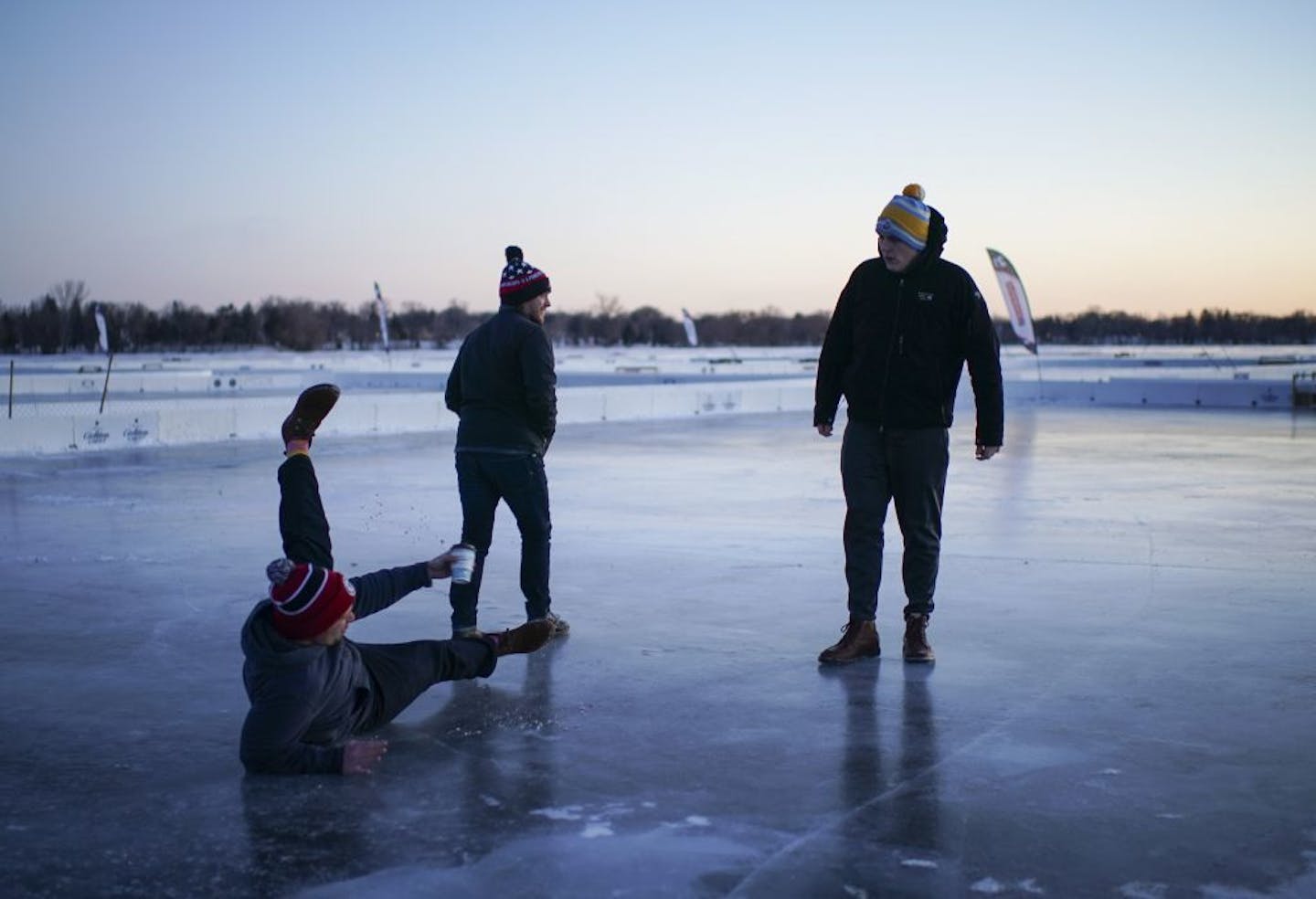 Collin McCullough spilled just a few drops of his coffee when he slipped on the ice while checking out one of the pond hockey rinks with Nick Lazenby, and Jordan Ricks, right. The three, all from Kansas City, are playing in the tournament.