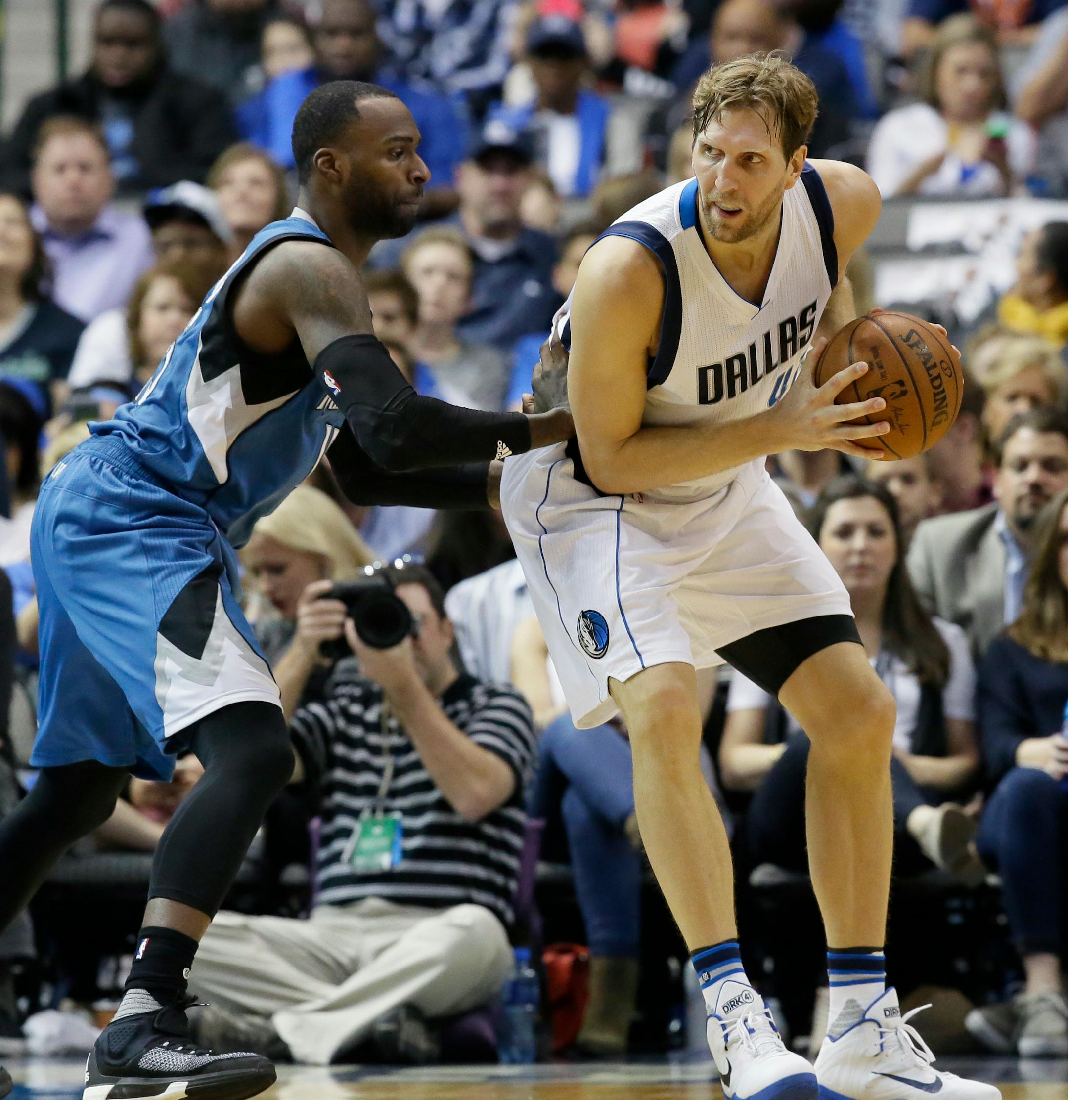Dallas Mavericks forward Dirk Nowitzki, right, is defended by Minnesota Timberwolves forward Shabazz Muhammad (15) during the first half of an NBA basketball game Sunday, Feb. 28, 2016, in Dallas. (AP Photo/LM Otero)