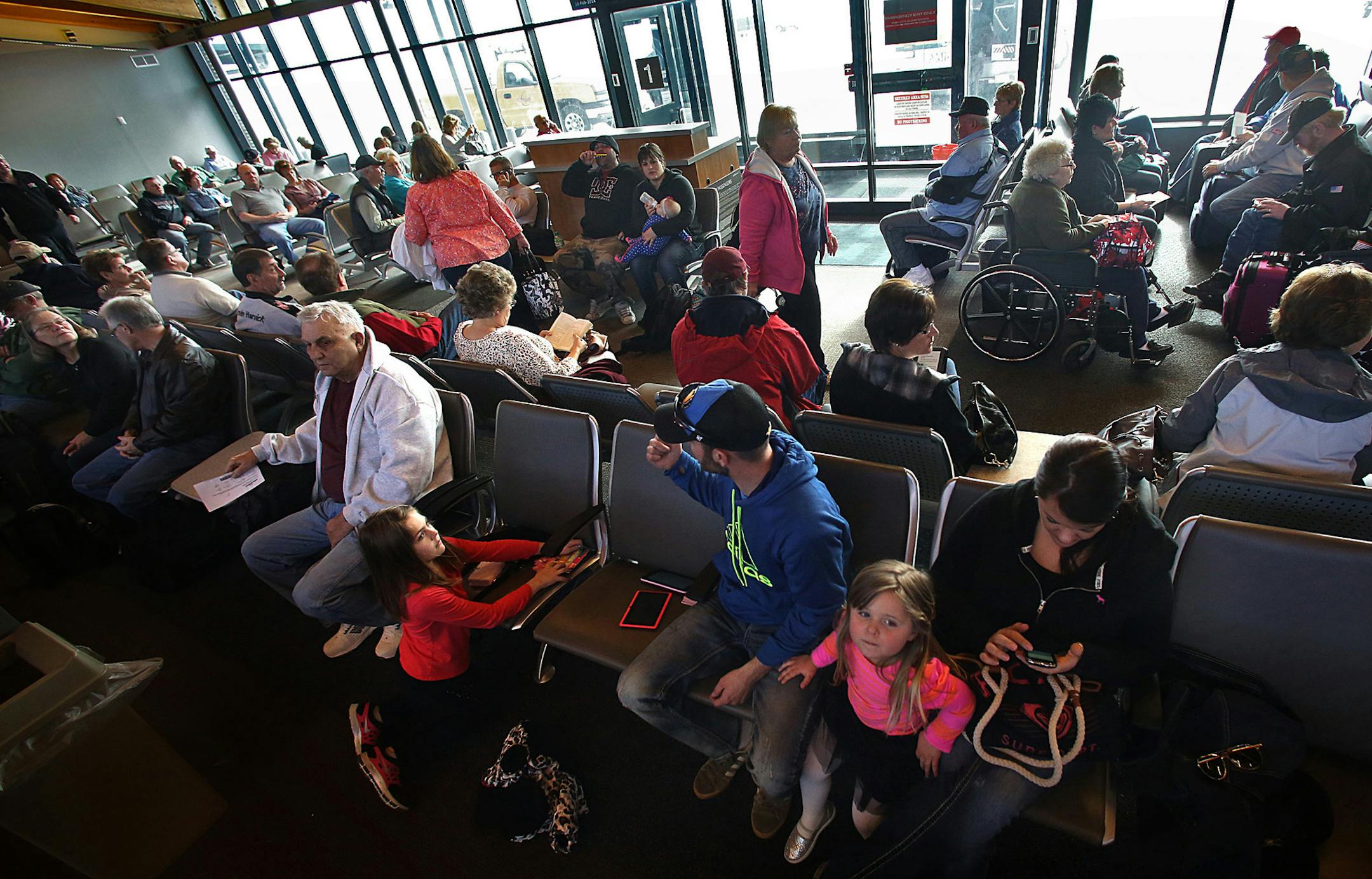 Passengers waited to board the flight to Phoenix, AZ. In foreground, Marissa, 8 (right) and Brookie, 3 Linow, ALexandria, waited patiently with their parents, Steve and Tara Linow, for the trip to see some of the children's' grandparents in Wickenburg, AZ. ] JIM GEHRZ ‚Ä¢ jgehrz@startribune.com / St. Cloud, MN / February 26, 20134/ 11:00 AM - BACKGROUND INFORMATION: Five years after Delta pulled its service from Minnesota's smaller airports amid a dismal time for airlines, there