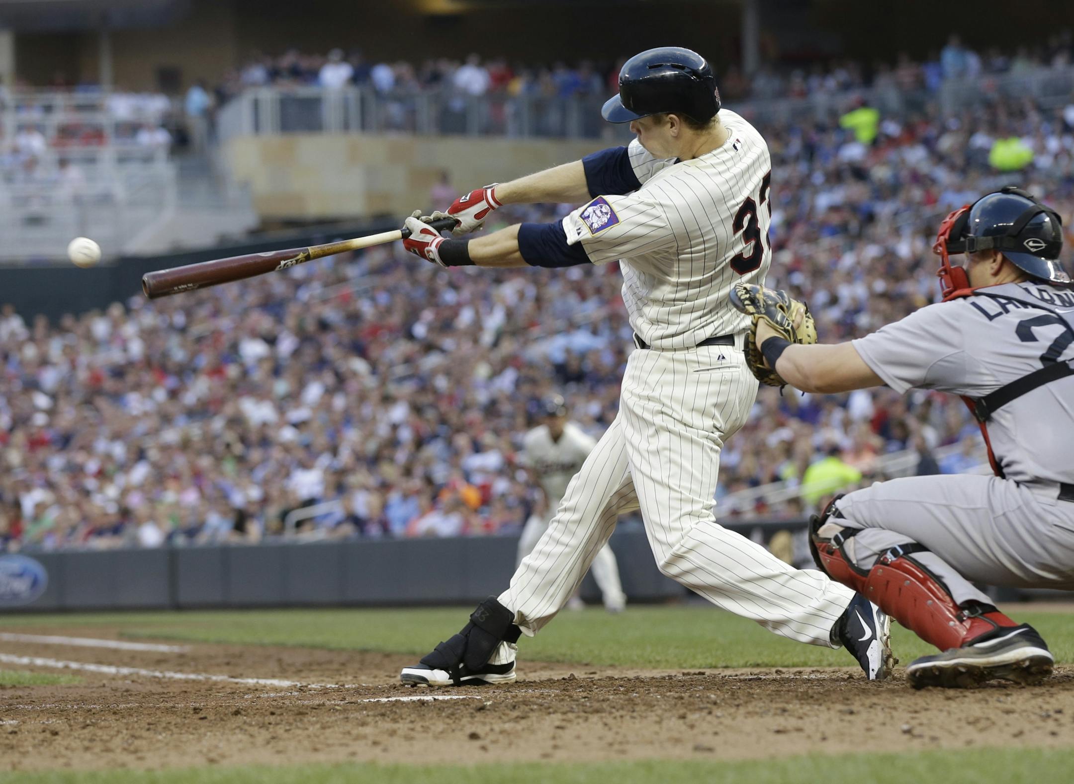 Minnesota Twins' Justin Morneau hits an RBI single off Boston Red Sox pitcher Ryan Dempster in the fourth inning of a baseball game, Saturday, May 18, 2013, in Minneapolis.