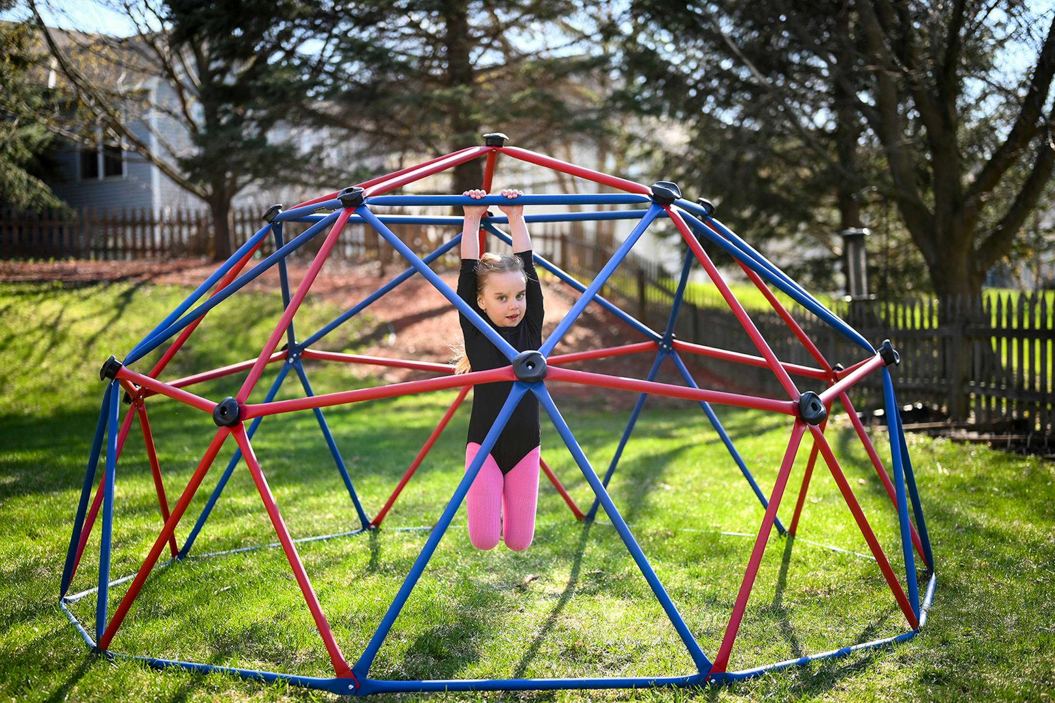 Eloise Gehring, 6, hung from her and her brother's backyard play set Wednesday in Woodbury. She says the pandemic makes her sad. "I just miss going to school, seeing my teacher and my friends," said Eloise. But it's not all bad. "Sometimes I get to watch tv for the whole day," Eloise boasted. She's also been taking an online dance class, playing outside and doing some gardening with her family. When the pandemic is over, she says she's "going to give lots and lots of hugs."