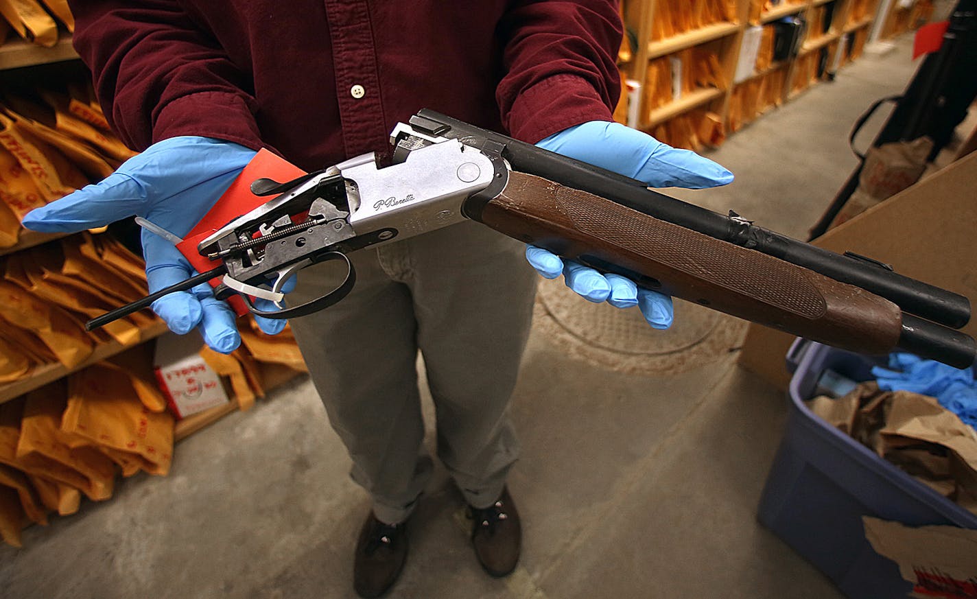 Kerstin Hammarberg, supervisor of the Minneapolis Property and Evidence Unit, displayed a seized sawed-off shotgun.