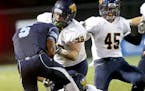 Blaine running back Chase Harper (5) loses the ball after being hit by Totino-Grace lineman Hunter Chistenon (78) during the first quarter Friday, Sep