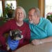 (Left to right) Faye Molnau held "Shadow" as her husband and caregiver, Jim Molnau, smiled at her. Jim and Faye Molnau are both 69 years old and live 