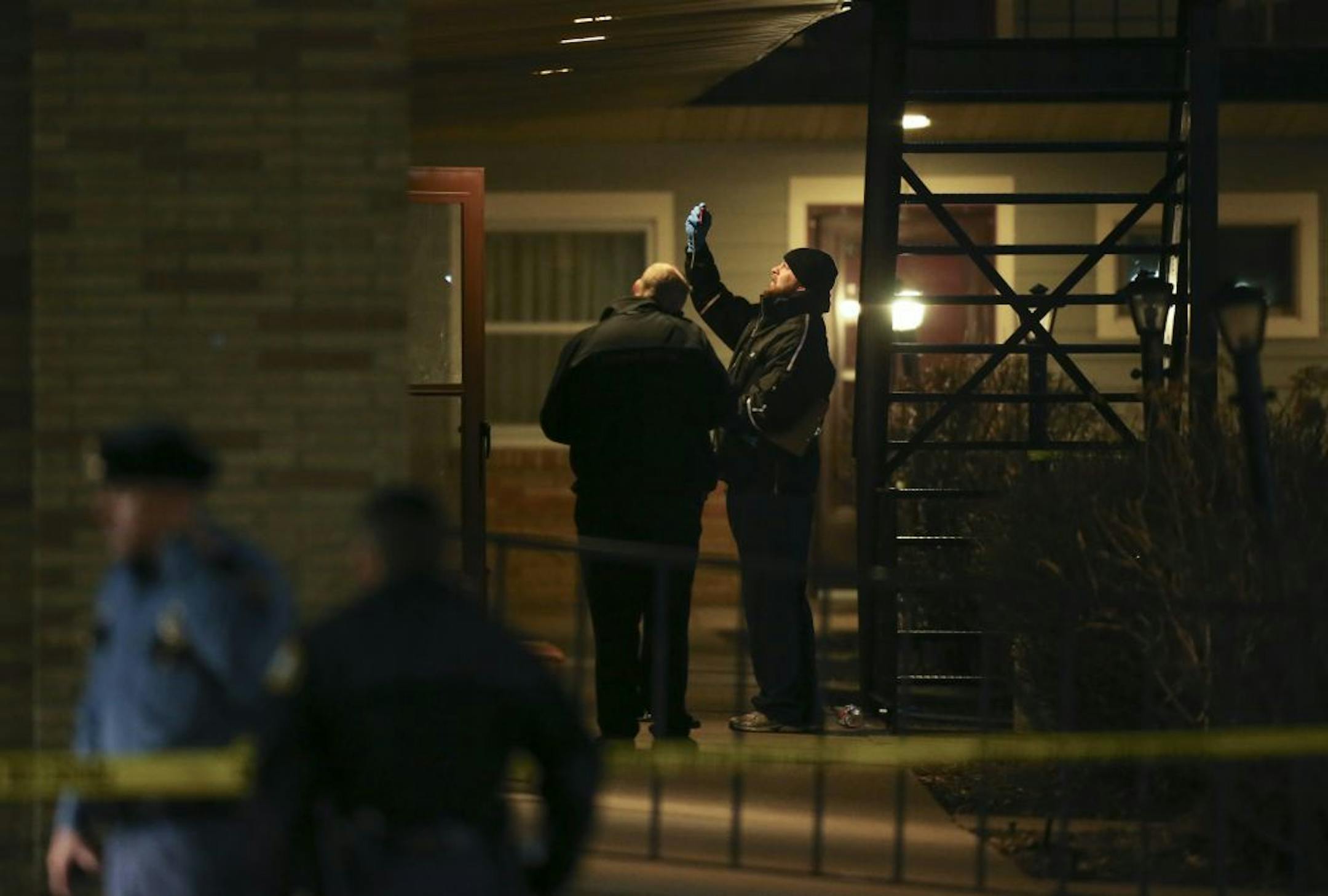 A man from the St. Paul Medical Examiner's office took a photo from outside a room at the Midway Motel late Tuesday night.