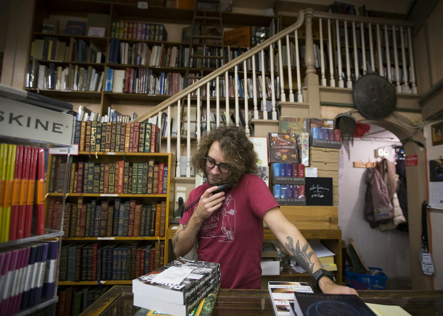 Conrad Mach called people to let them know the book the ordered was in at Magers and Quinn on Friday, November 20, 2015, in Minneapolis, Minn. Mach is one of the employees choosing to work on Thanksgiving day at the bookstore. ] RENEE JONES SCHNEIDER &#x2022; reneejones@startribune.com