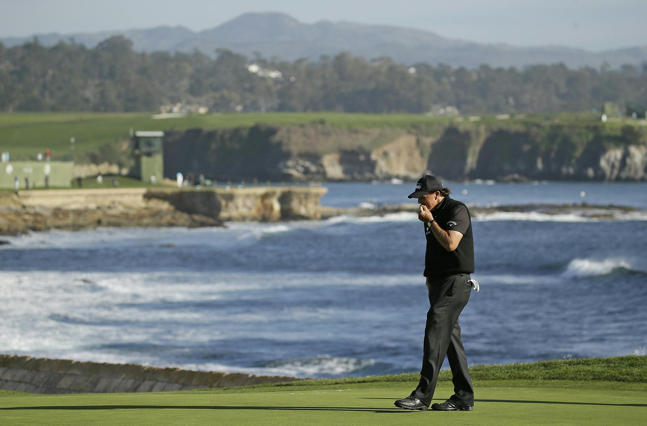 Phil Mickelson reacts after missing a birdie putt on the 18th green of the Pebble Beach Golf Links during the final round of the AT&T Pebble Beach National Pro-Am golf tournament Sunday, Feb. 14, 2016, in Pebble Beach, Calif. Vaughn Taylor won the tournament. (AP Photo/Eric Risberg)