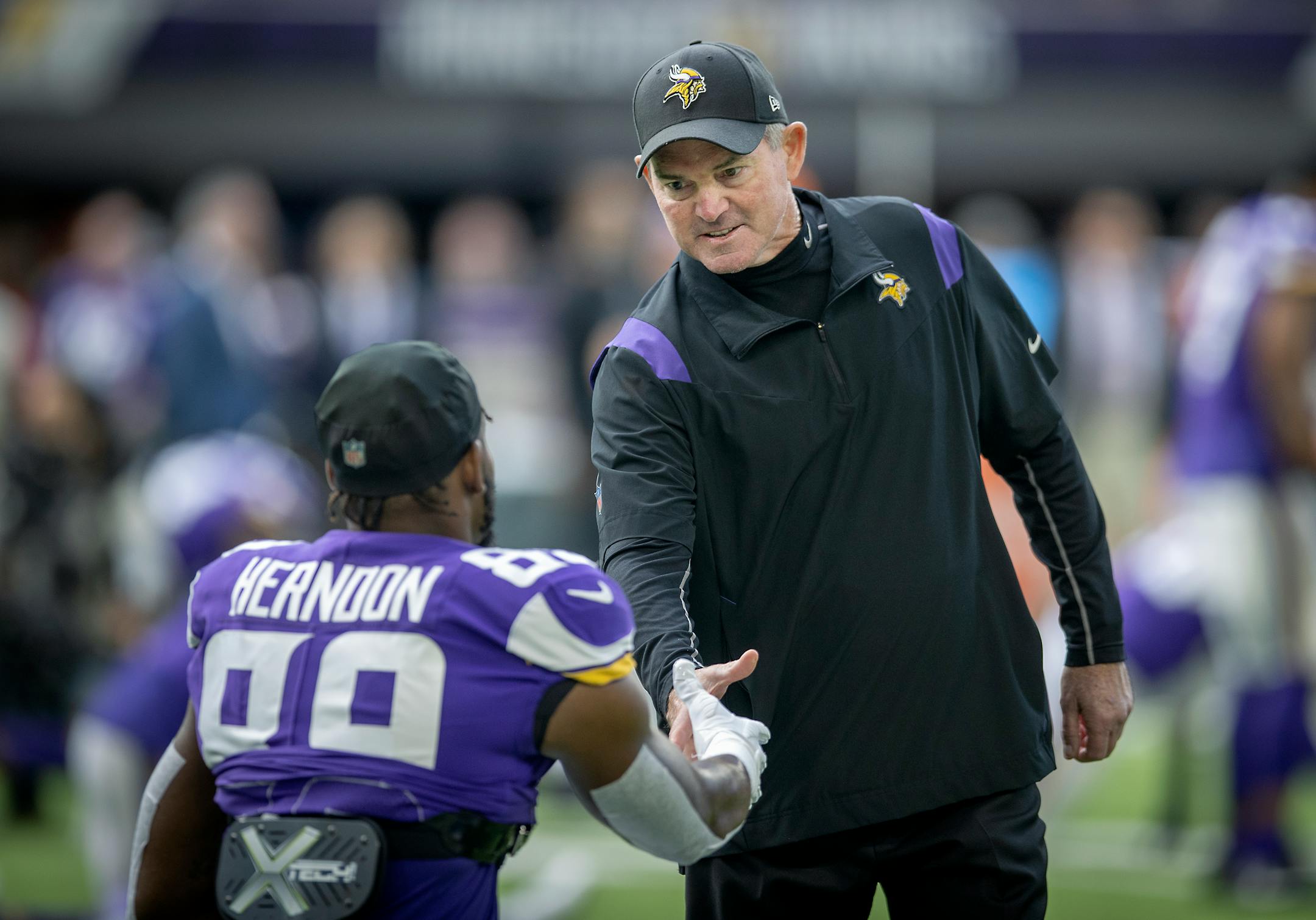 Vikings Head Coach Mike Zimmer greeted players including Vikings tight end Chris Herndon (89) before the game.
