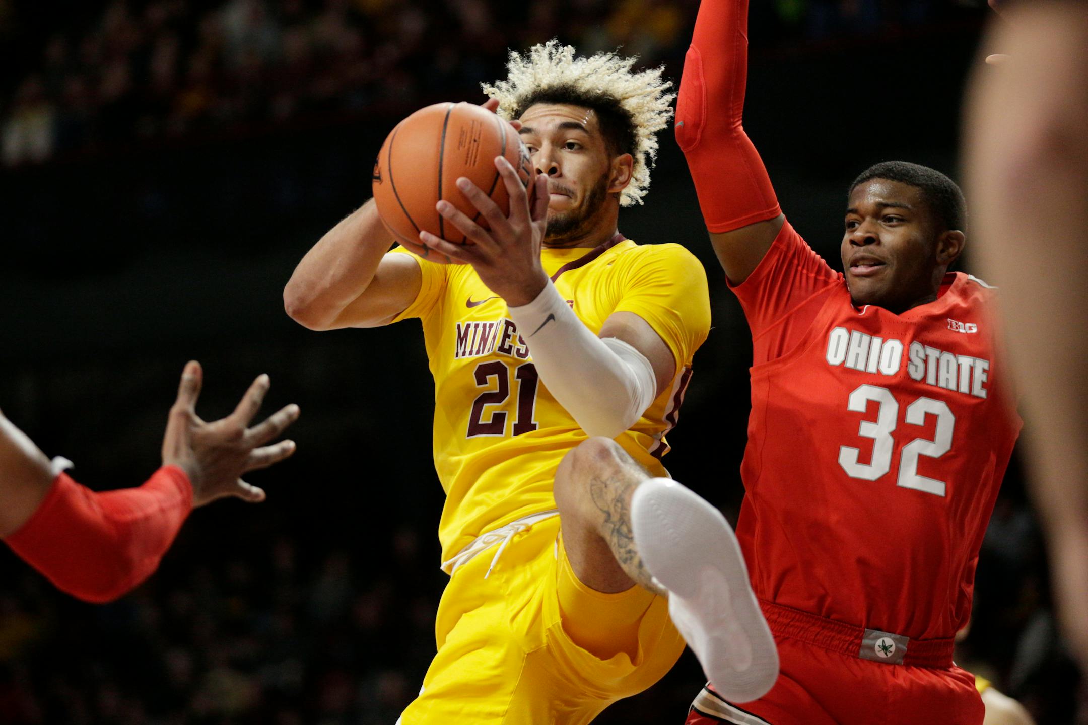 Gopehrs forward Jarvis Omersa grabs a rebound in front of Ohio State guard E.J. Liddell in the first half