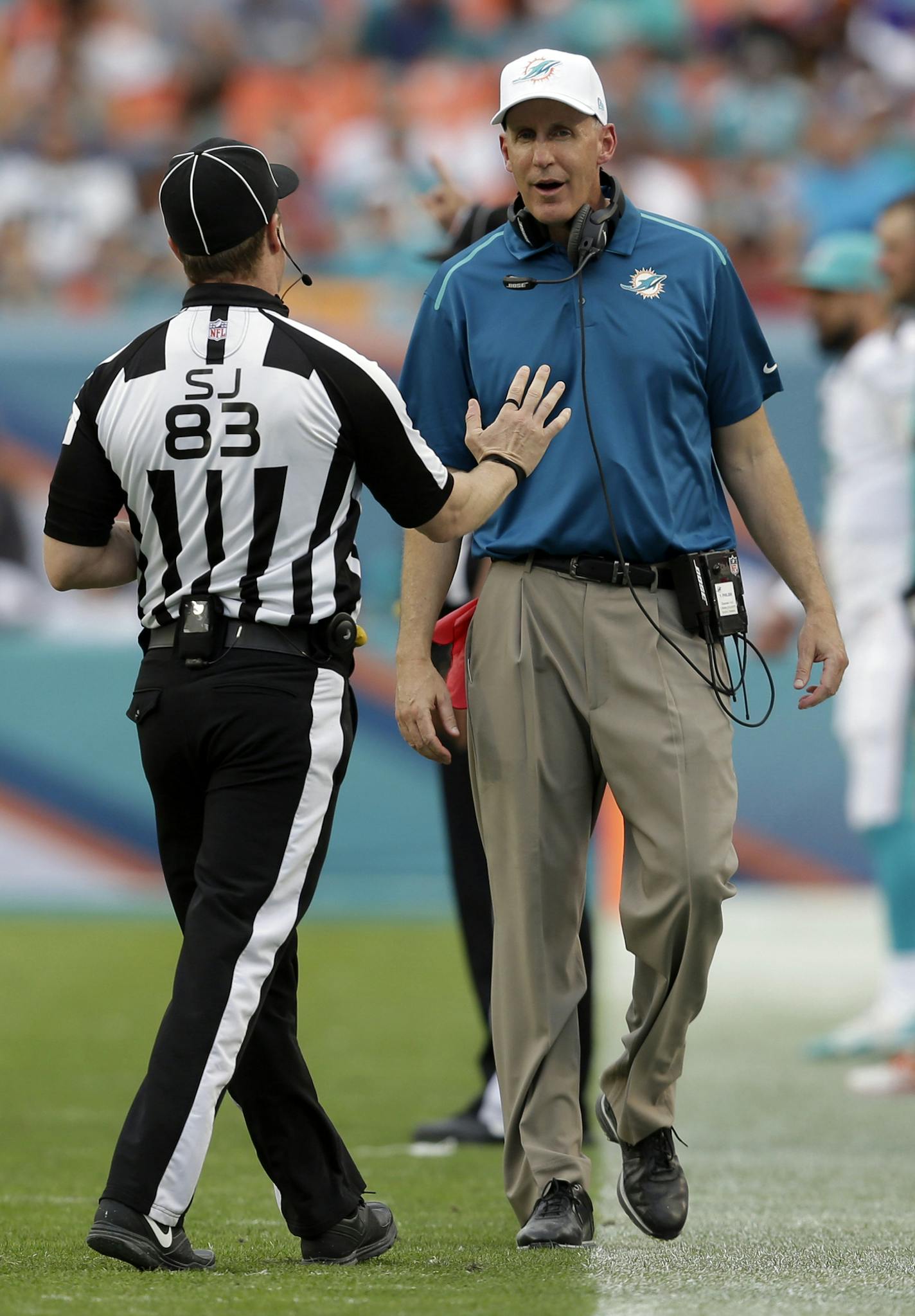 Miami Dolphins head coach Joe Philbin, right, argues a call with side coach Shawn Hochuli during the second half of an NFL football game against the Minnesota Vikings, Sunday, Dec. 21, 2014, in Miami Gardens, Fla. (AP Photo/Wilfredo Lee) ORG XMIT: SLS121